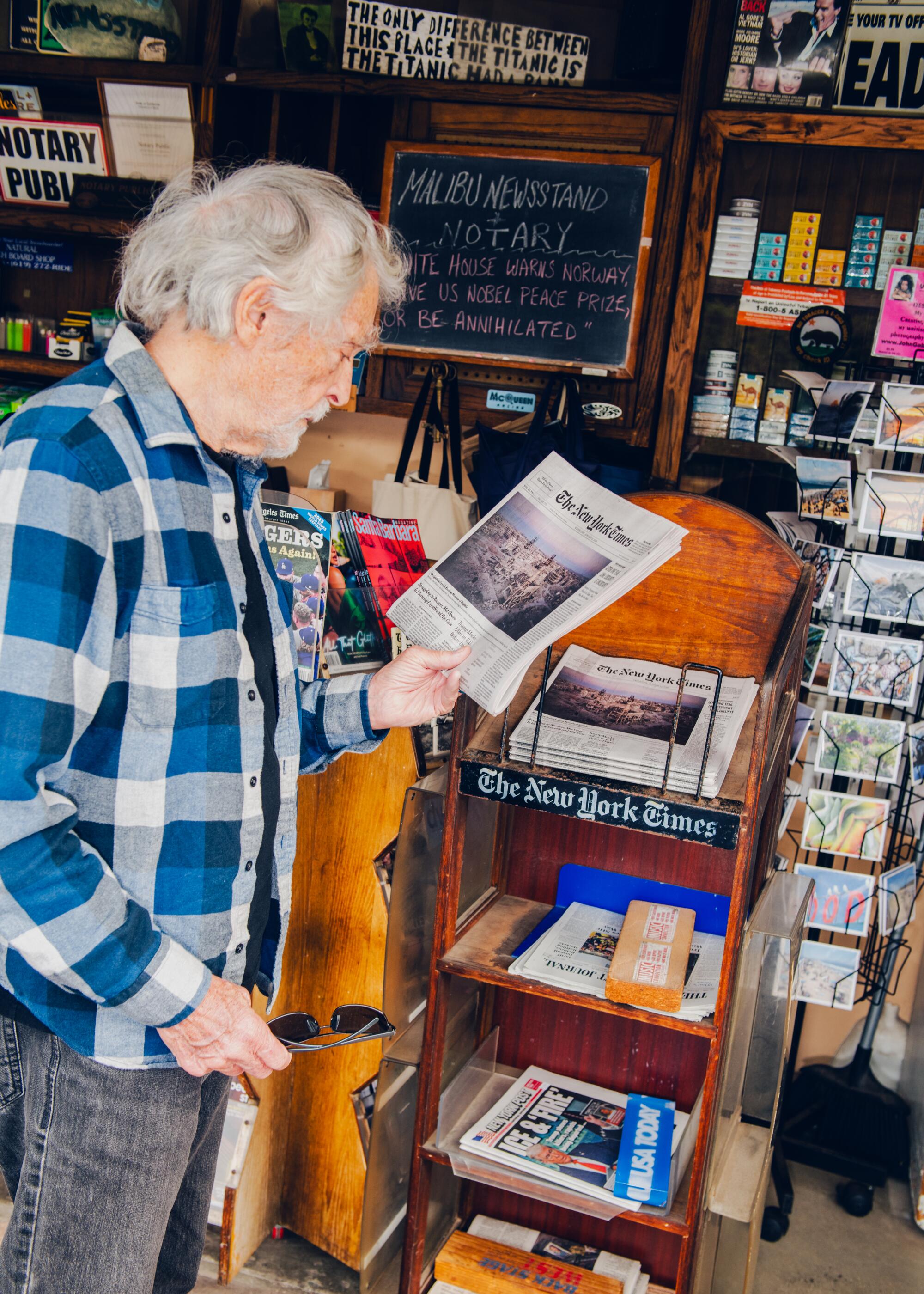 Malibu Newsstand. A customer reads the headlines of The New York Times.