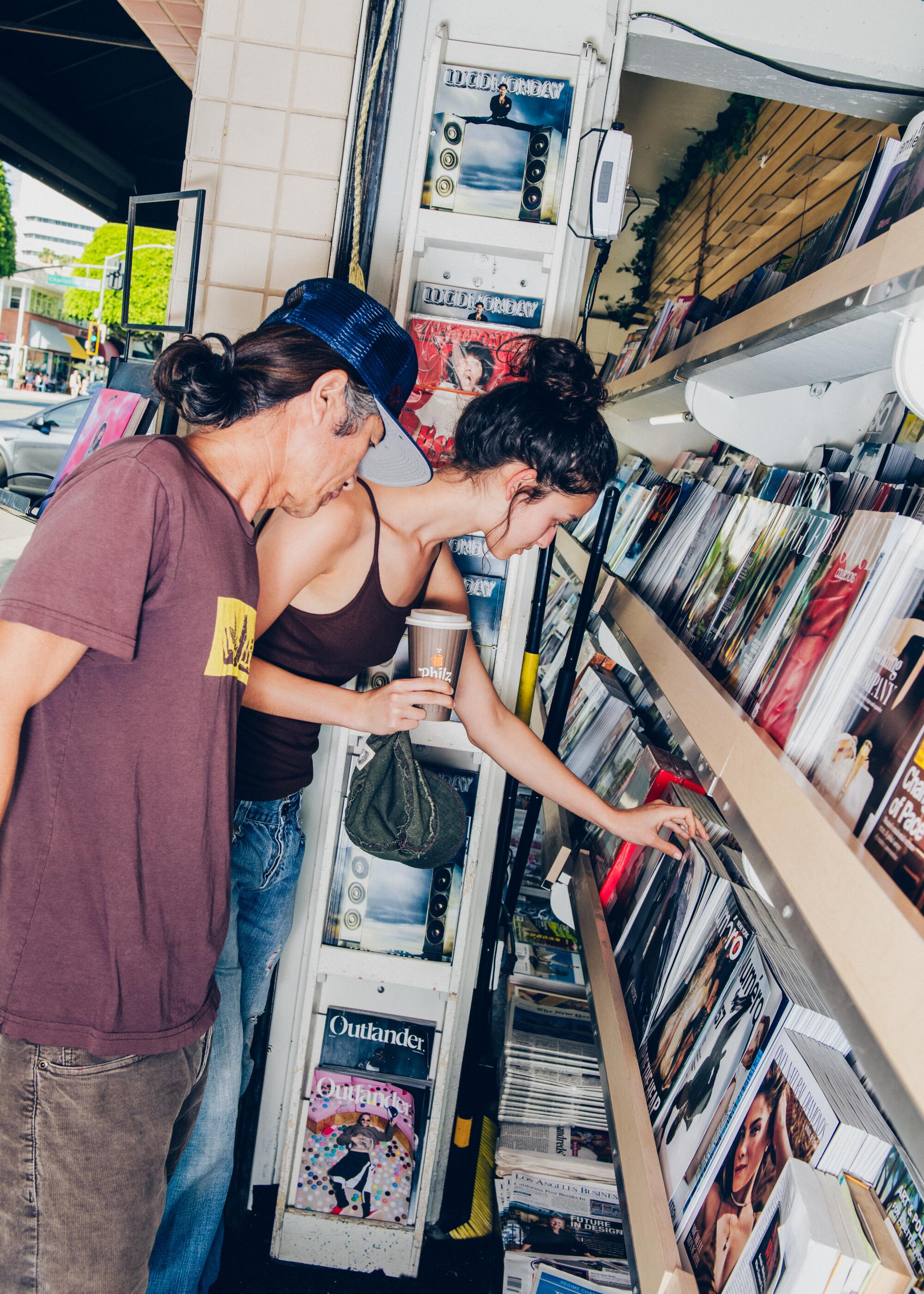 Customers Sonam Tsering (L) and Trinley Tsering (R) browsing magazines at Beverly Hills Newsstand. 