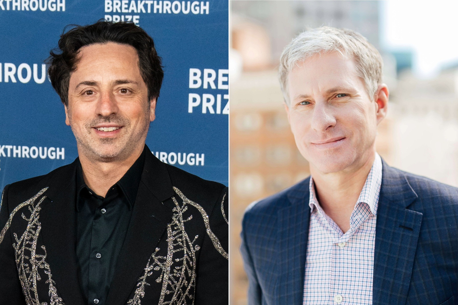 A man with dark wavy hair wears a black jacket with silver embroidery, smiling in front of a blue "Breakthrough Prize" backdrop; another man with short grey hair wears a blue checkered suit and smiles softly against a blurred cityscape background.