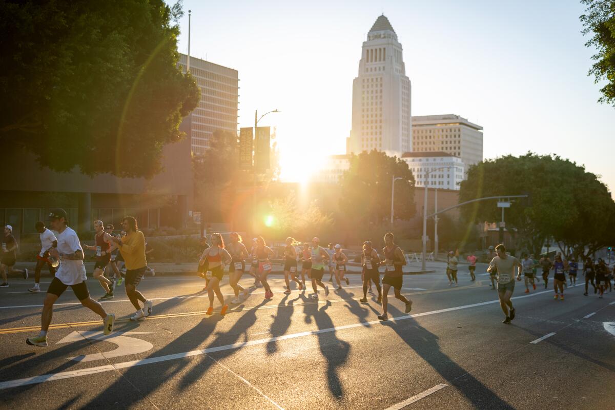 Runners pass by City Hall during the 41st Los Angeles Marathon 