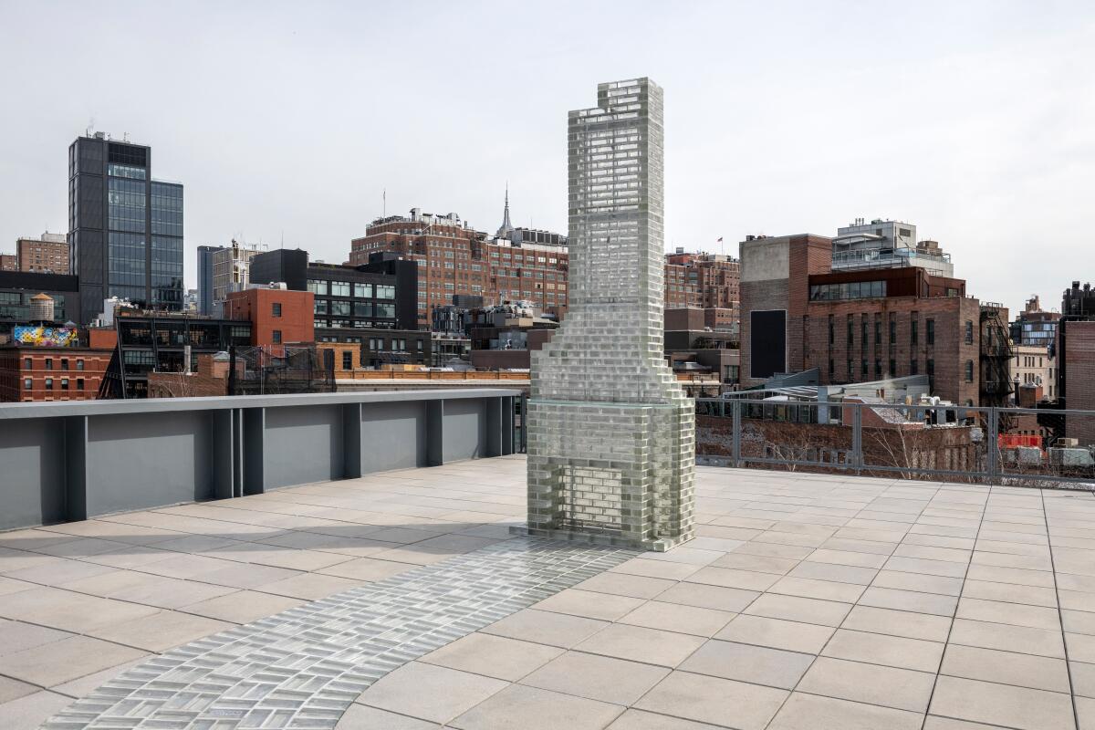 A sculpture of a chimney on a patio.