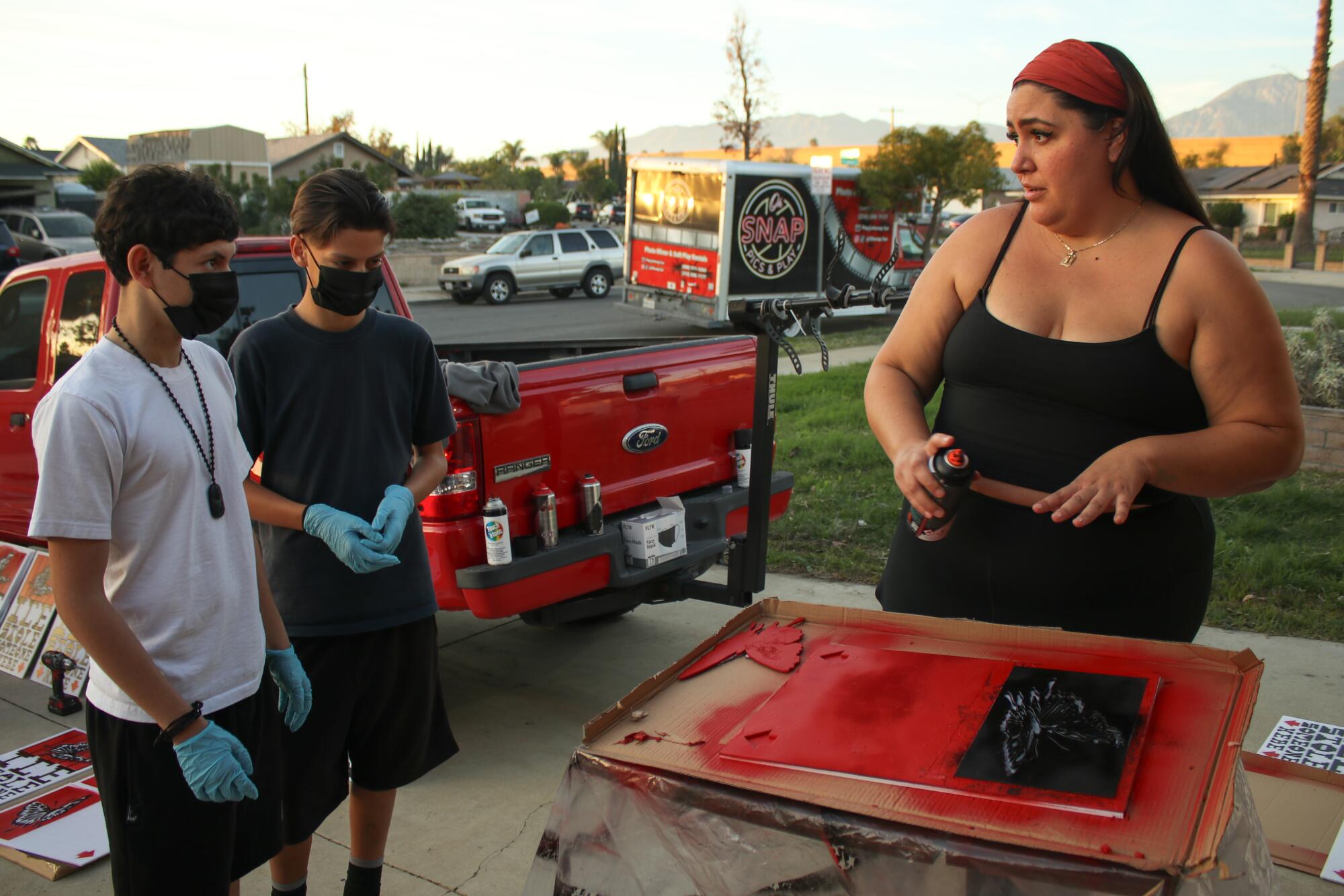 Andrea Galvan outside with two young neighbors