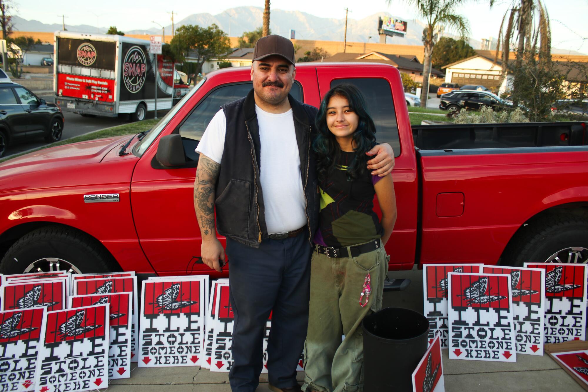 Two  people surrounded by signs