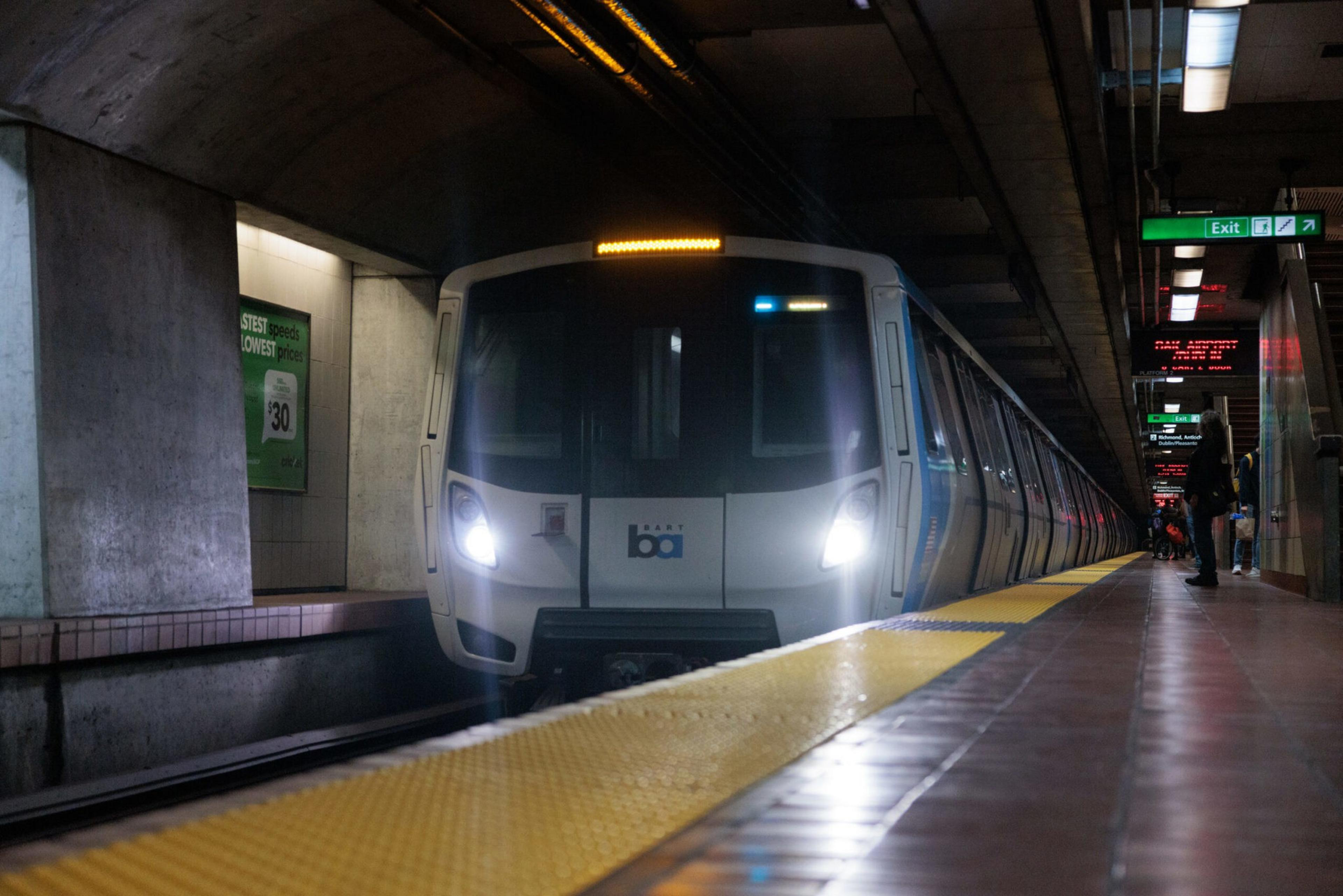 A train approaches a subway platform.