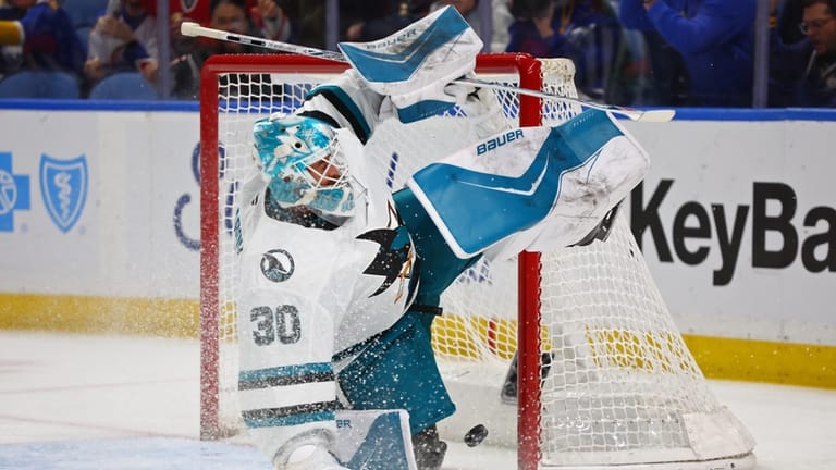 San Jose Sharks goaltender Yaroslav Askarov (30) slides across the...