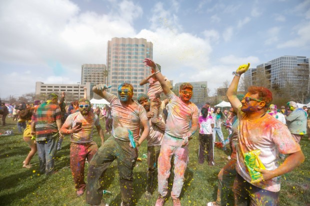 People dance during Holi Fest hosted by the Association of Indo Americans at Discovery Meadow in San Jose, Calif., on Saturday, March 15, 2025. (Shae Hammond/Bay Area News Group)