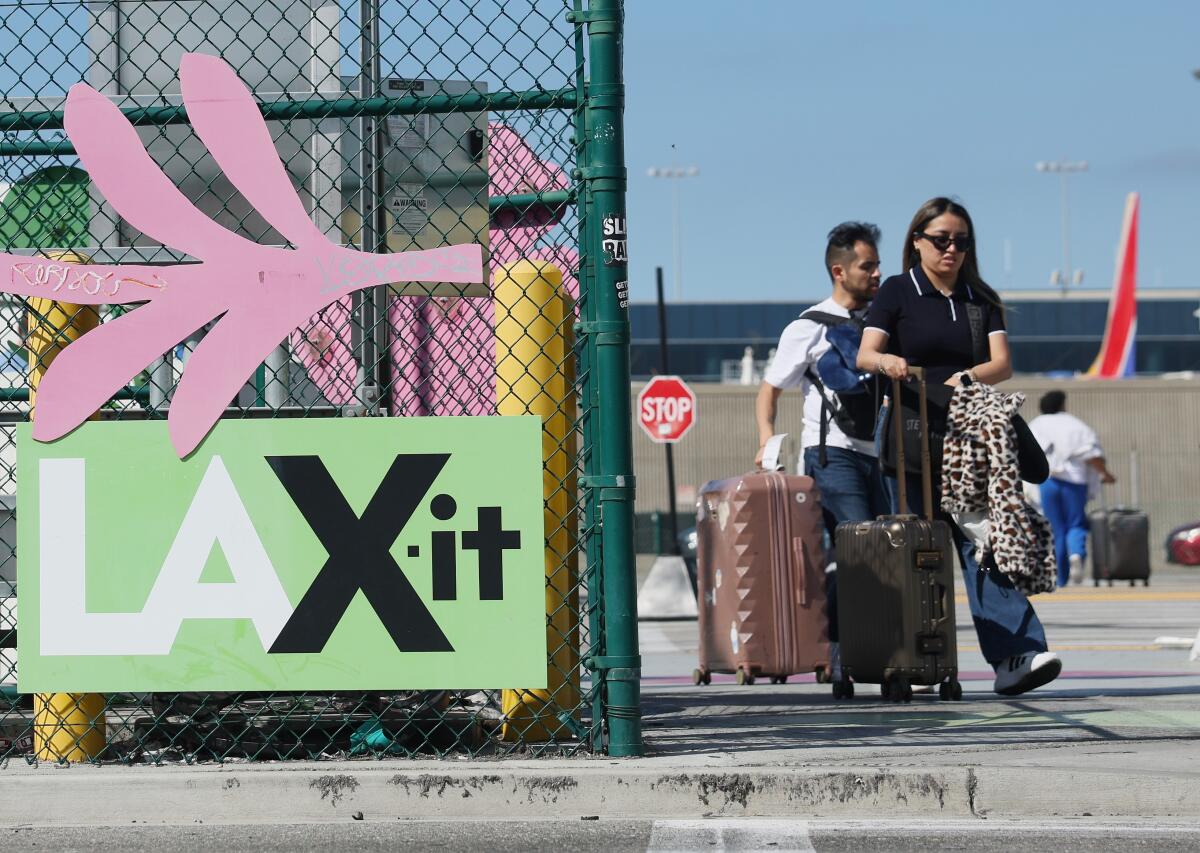 People walk with luggage.
