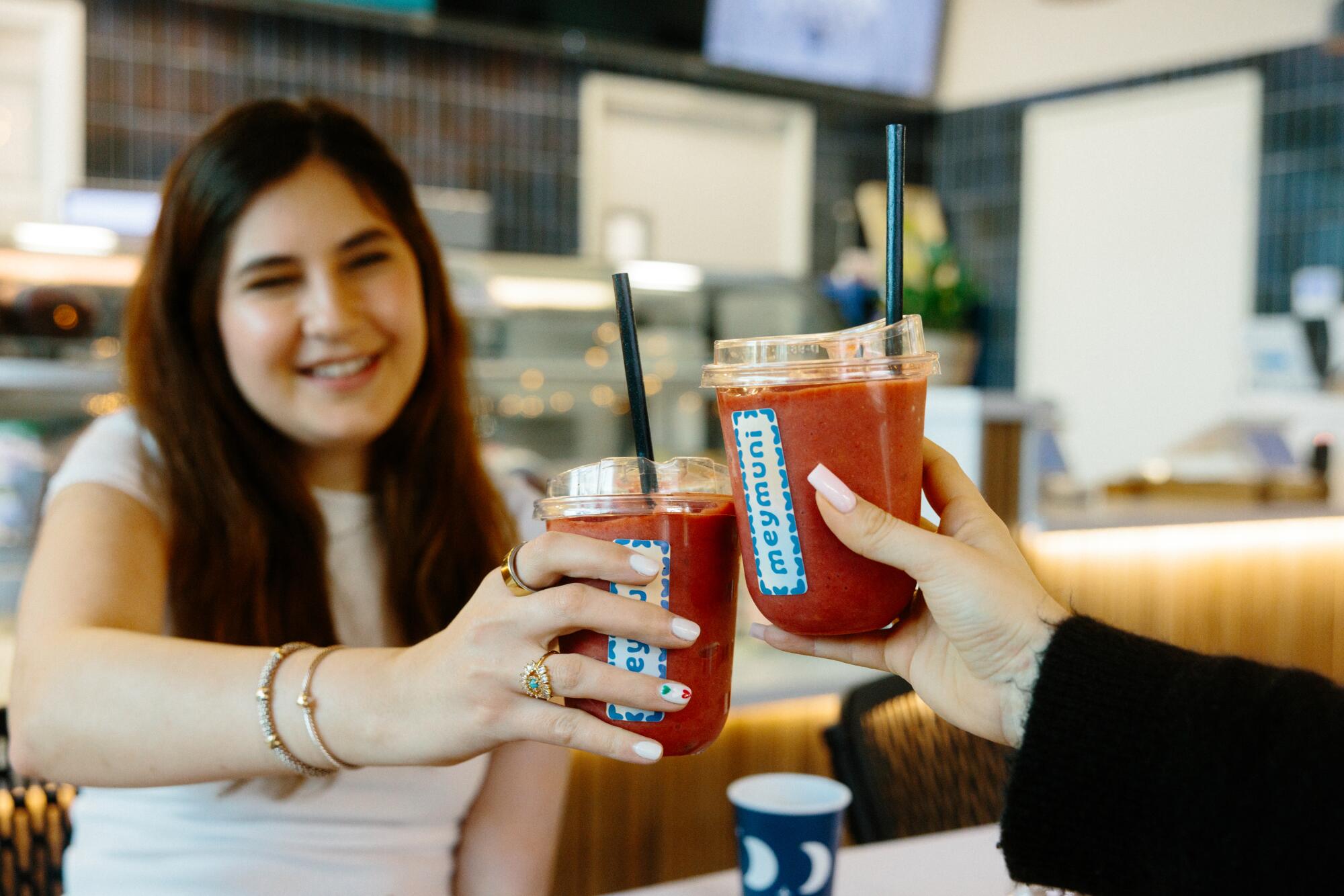 Suzan Mehrabian and Nikki Amiri enjoy drinks at Meymuni Cafe.