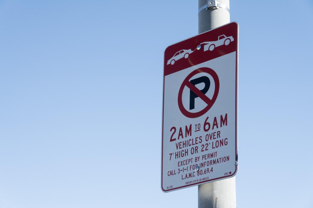 A restricted-parking sign on a pole.