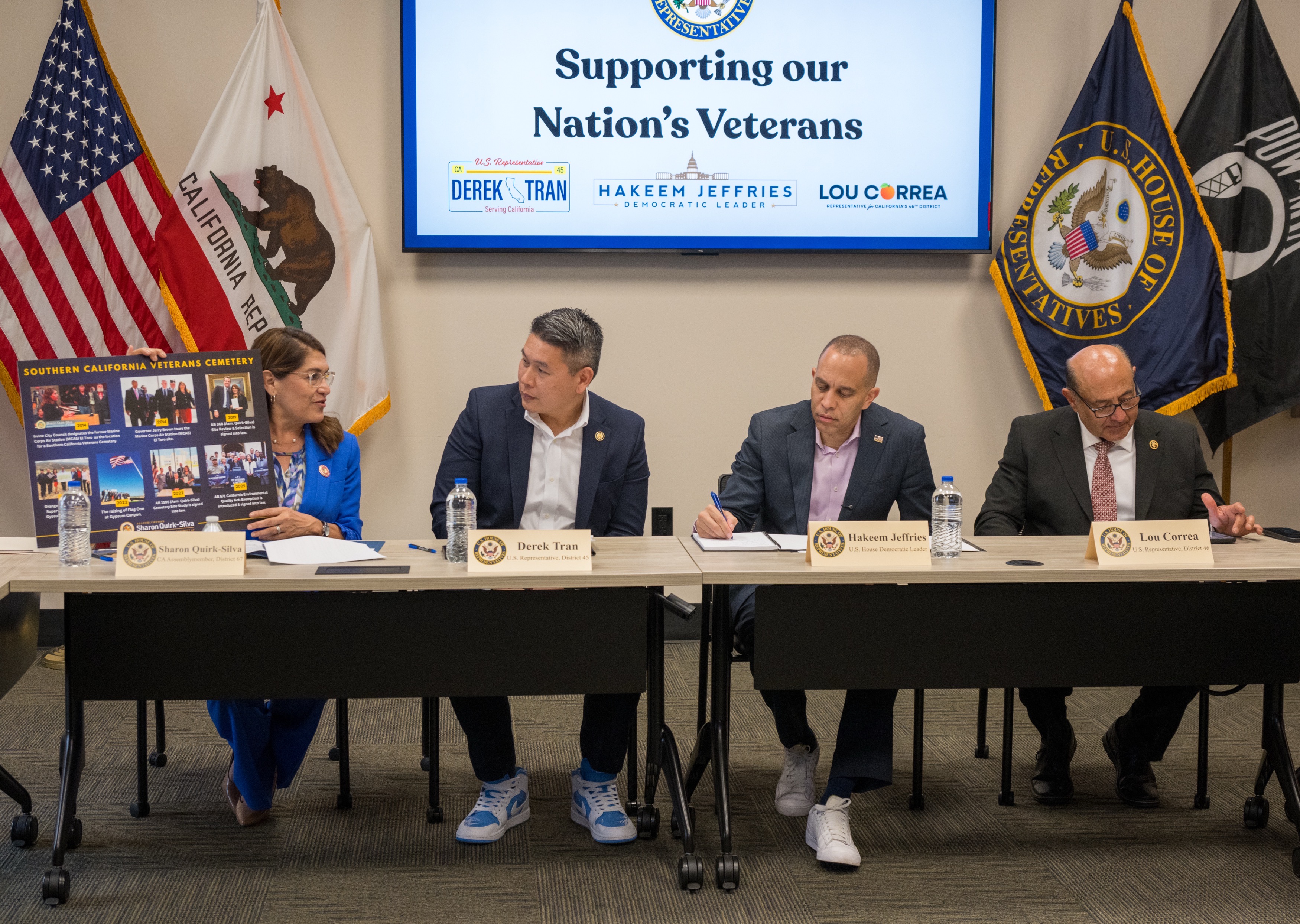 Assemblymember Sharon Quirk-Silva, left, shows a board with highlights of...