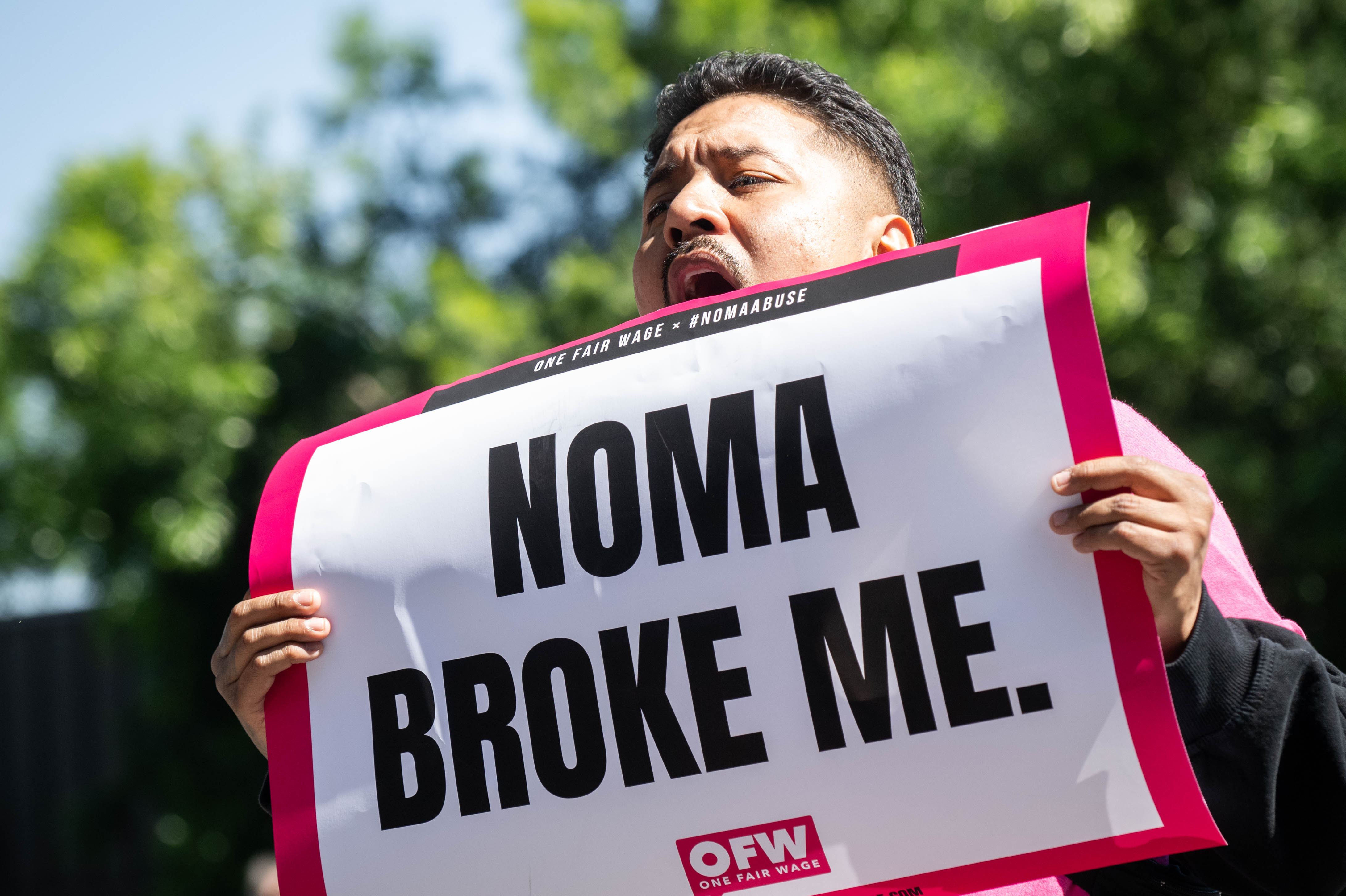 A protester chants outside the NOMA LA pop-up where $1,500...