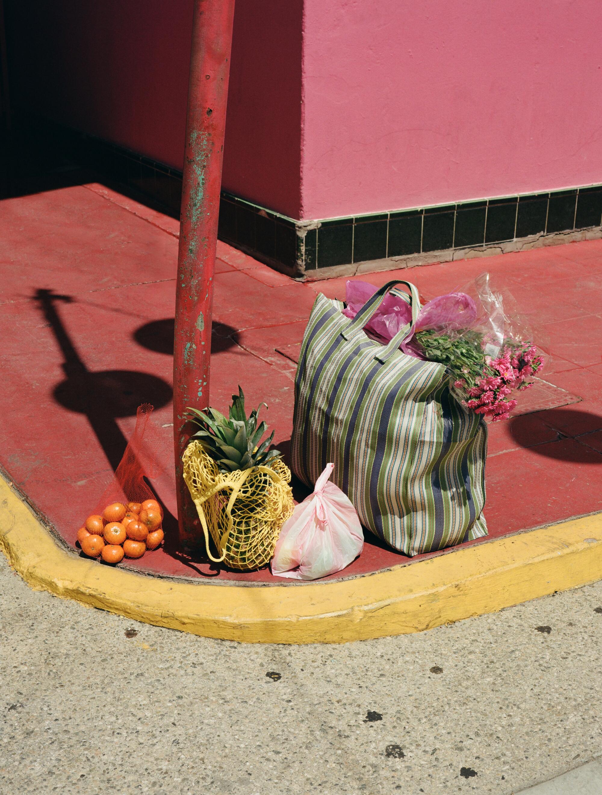 Stylist’s own striped shopping tote and yellow mesh tote.