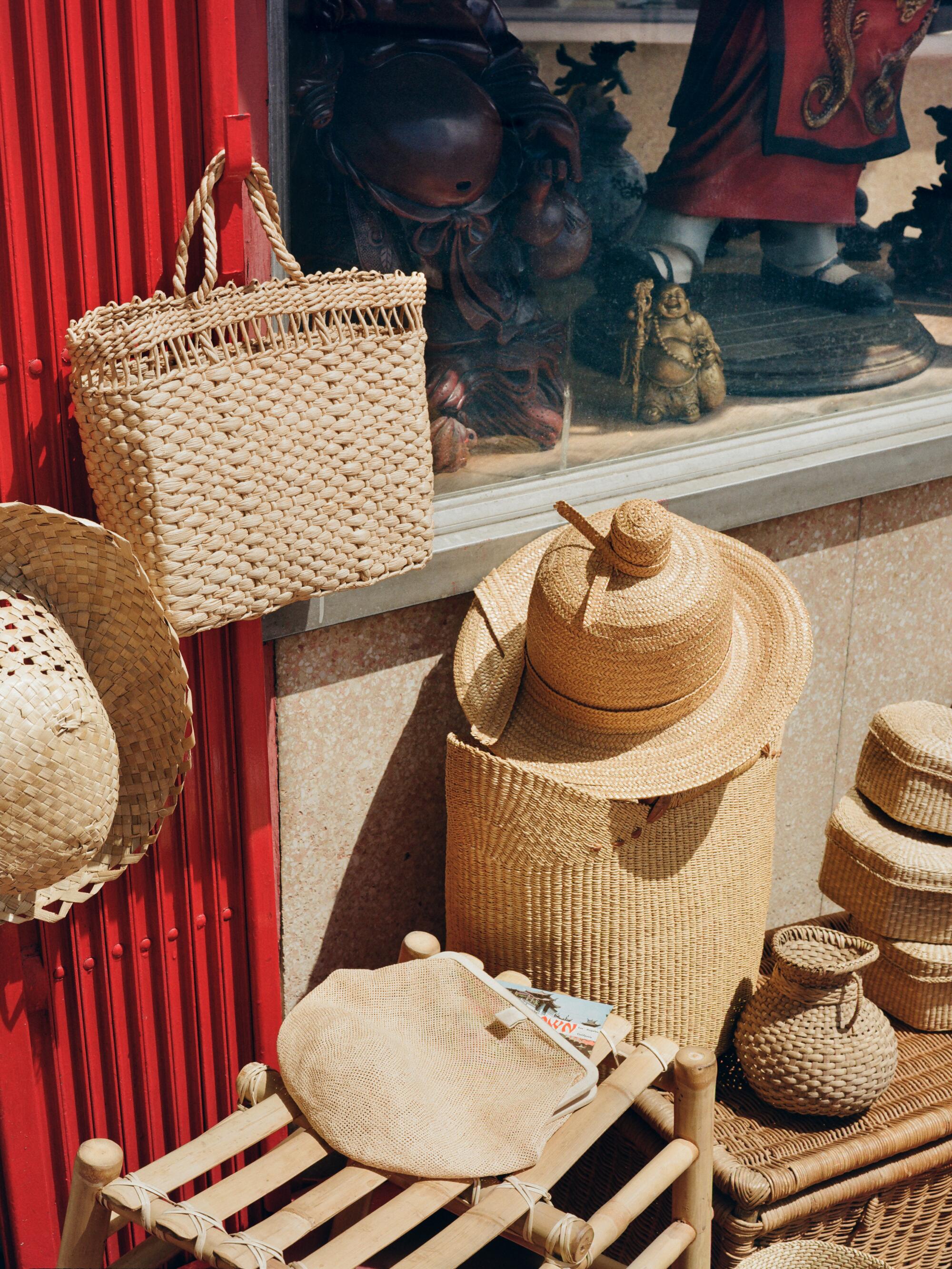 Purse and slated stool. Vintage Italian nob top straw hat, Chinese wicker baskets, wicker vase, and square wicker trunk.