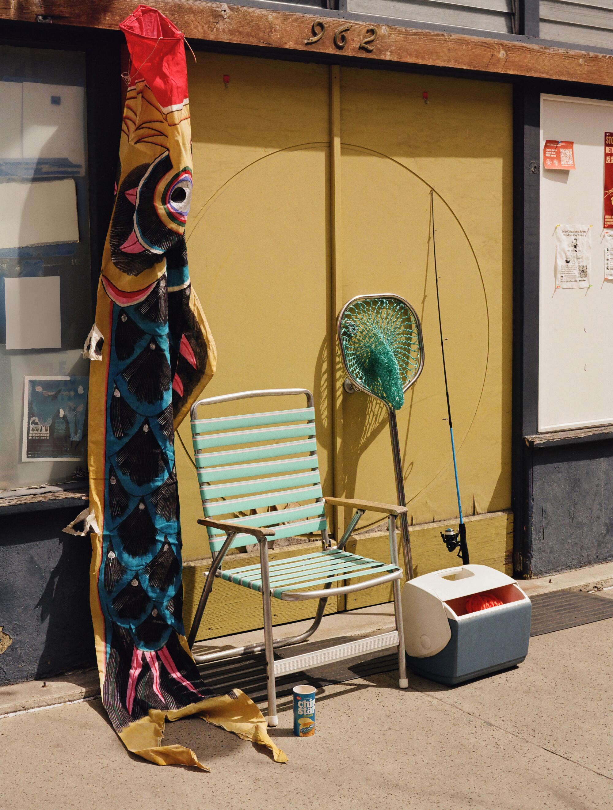 Vintage Japanese Koinobori carp windsock, stylist’s own vintage folding chair, fishing net and cooler.
