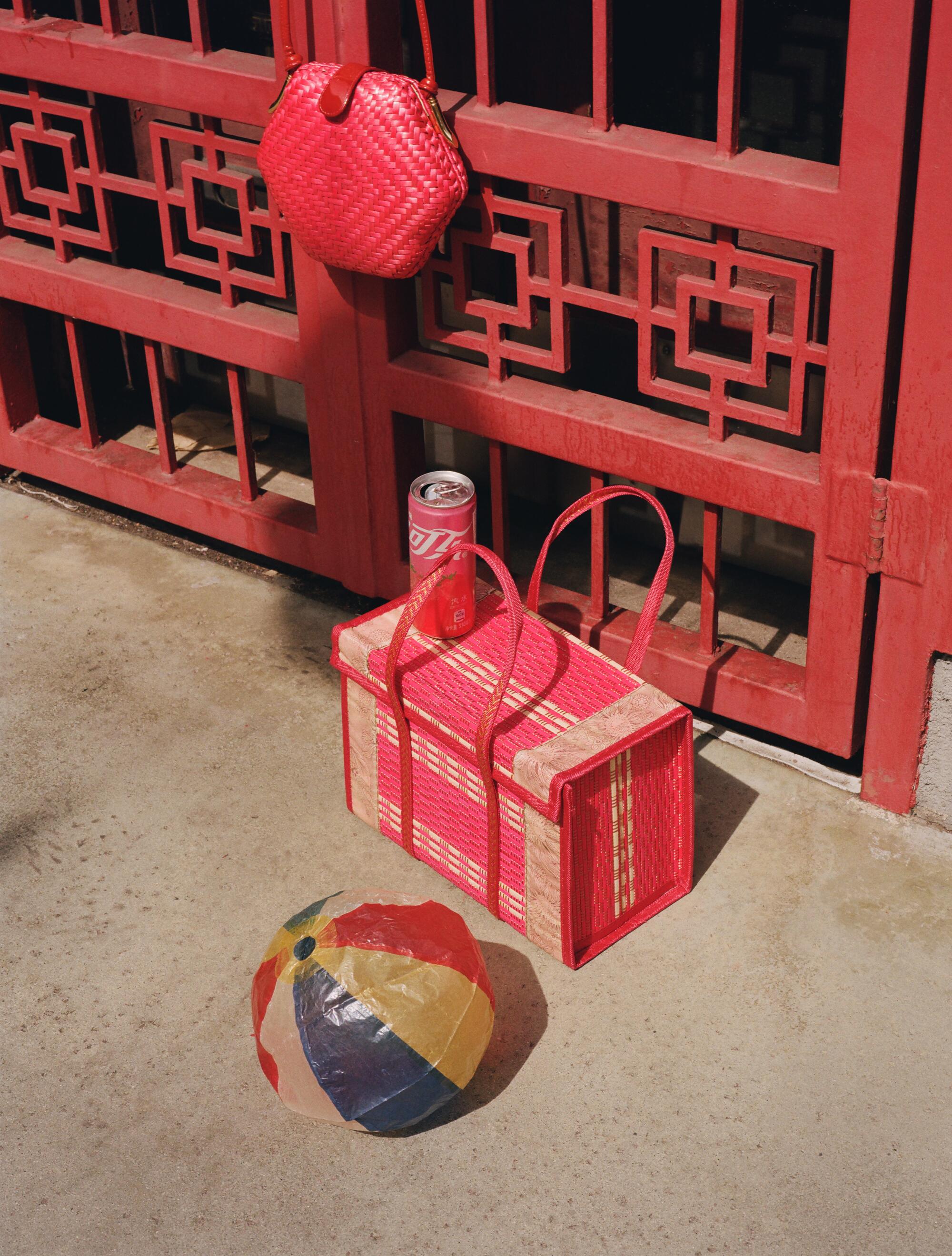 Photographer’s own vintage hexagonal bag and woven basket with handles. Stylist’s own vintage beach balls.