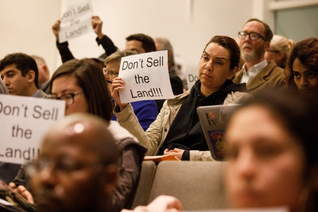 SAN JOSE, CALIFORNIA- DECEMBER, 4: Liz Gonzalez of San Jose, center right, and fellow opponents of the proposed Google project near Diridon Station hold signs during the San Jose City Council meeting on December, 4, 2018, in San Jose. The San Jose City Council is expected to formally approve the sale of city-owned land to Google Tuesday, moving forward plans for a massive mixed-use development near Diridon Station that is expected to be the biggest project downtown in generations. (Dai Sugano/Bay Area News) Group)