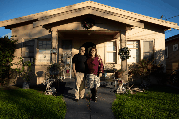 Martin and Elizabeth Pacheco stand outside their rental home on Lorraine Avenue in San Jose, April 17, 2019. The property, where the family lived for 16 years, was later purchased by Google. The yellow bungalow still stands, March 5, 2026. (Randy Vazquez and Dai Sugano/Bay Area News Group)