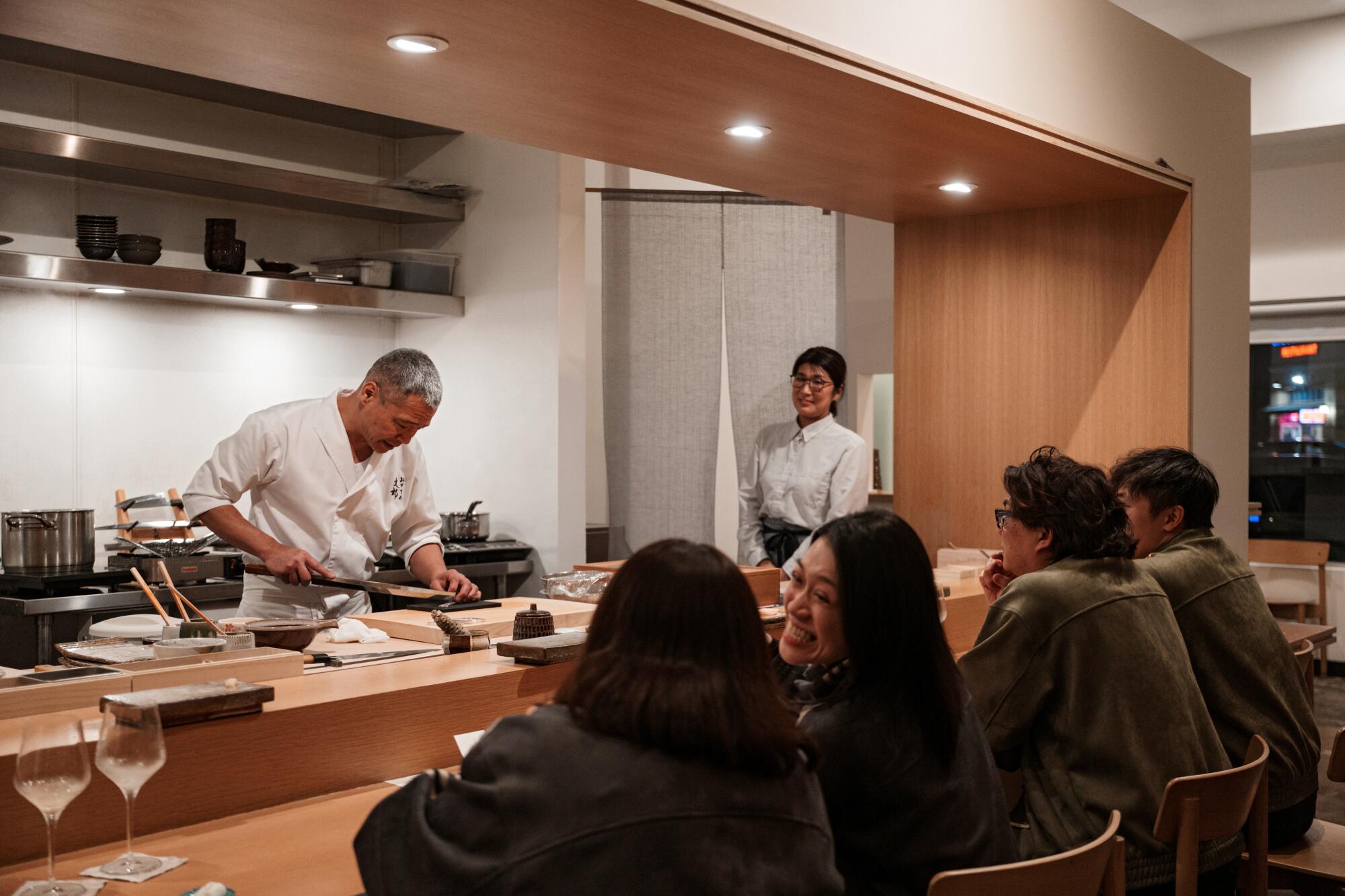 Chef-owner Fumio Azumi in the kitchen preparing nigiri for guests at Osusume Fumio.
