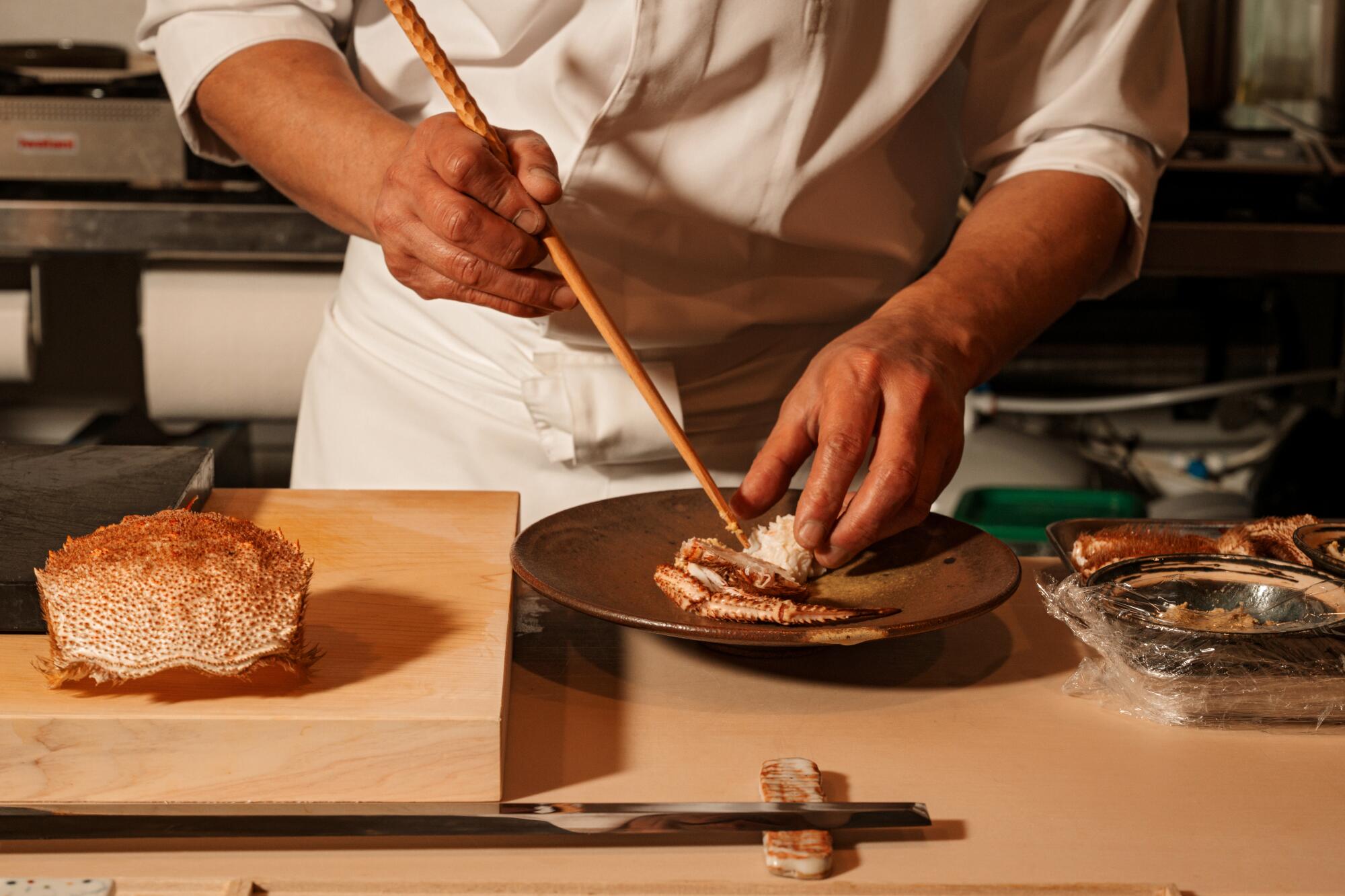 Chef-Owner Fumio Azumi in the kitchen preparing the Kegani (hairy crab) appetizer at Osusume Fumio.