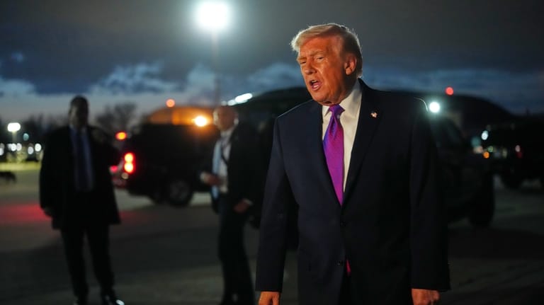 President Donald Trump speaks to reporters after arriving on Air...