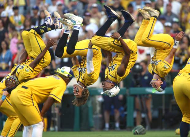 The Savannah Bananas flip in the air during the exhibition baseball game. The team is known for its highly choreographed dance routines in striking yellow uniforms. The game was held at Angel Stadium in Anaheim on Friday May 30, 2025. (Karen Tapia, Contributing Photographer)