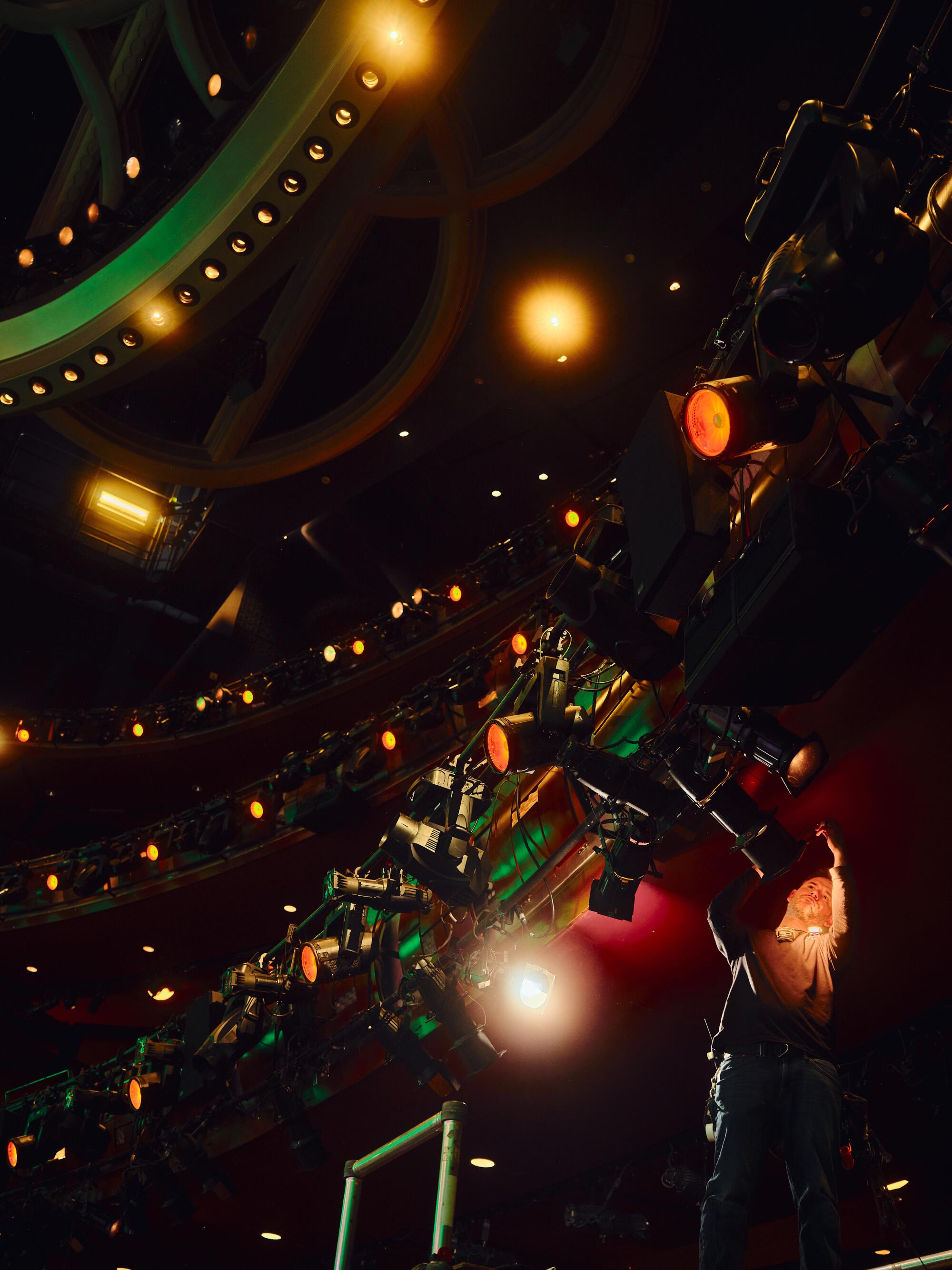 A man moves the balcony lighting equipment. 