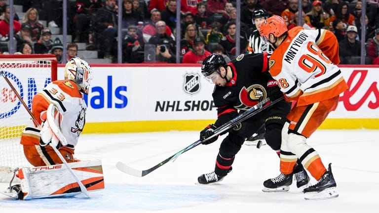 Ottawa Senators' Drake Batherson (19) looks for the puck between...