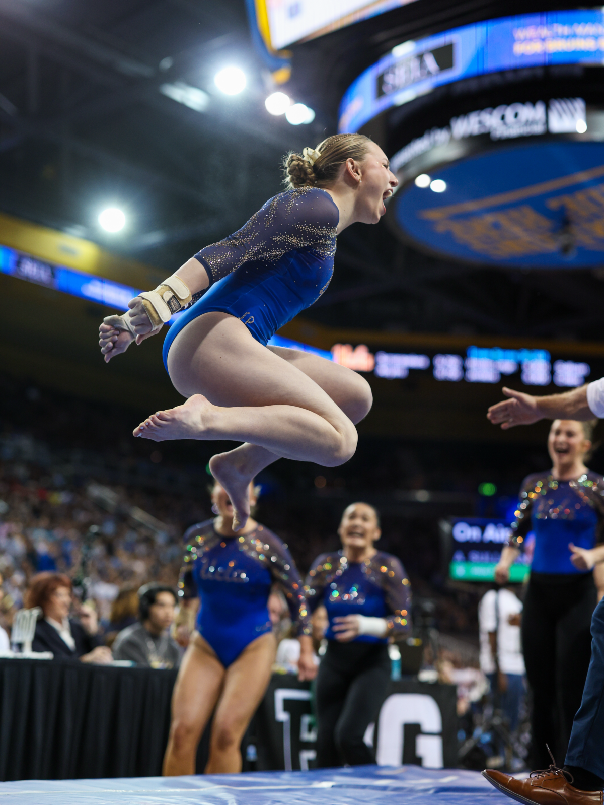 Ashlee Sullivan celebrates after completing a vault that earned a score of 9.975 during a meet against Utah.