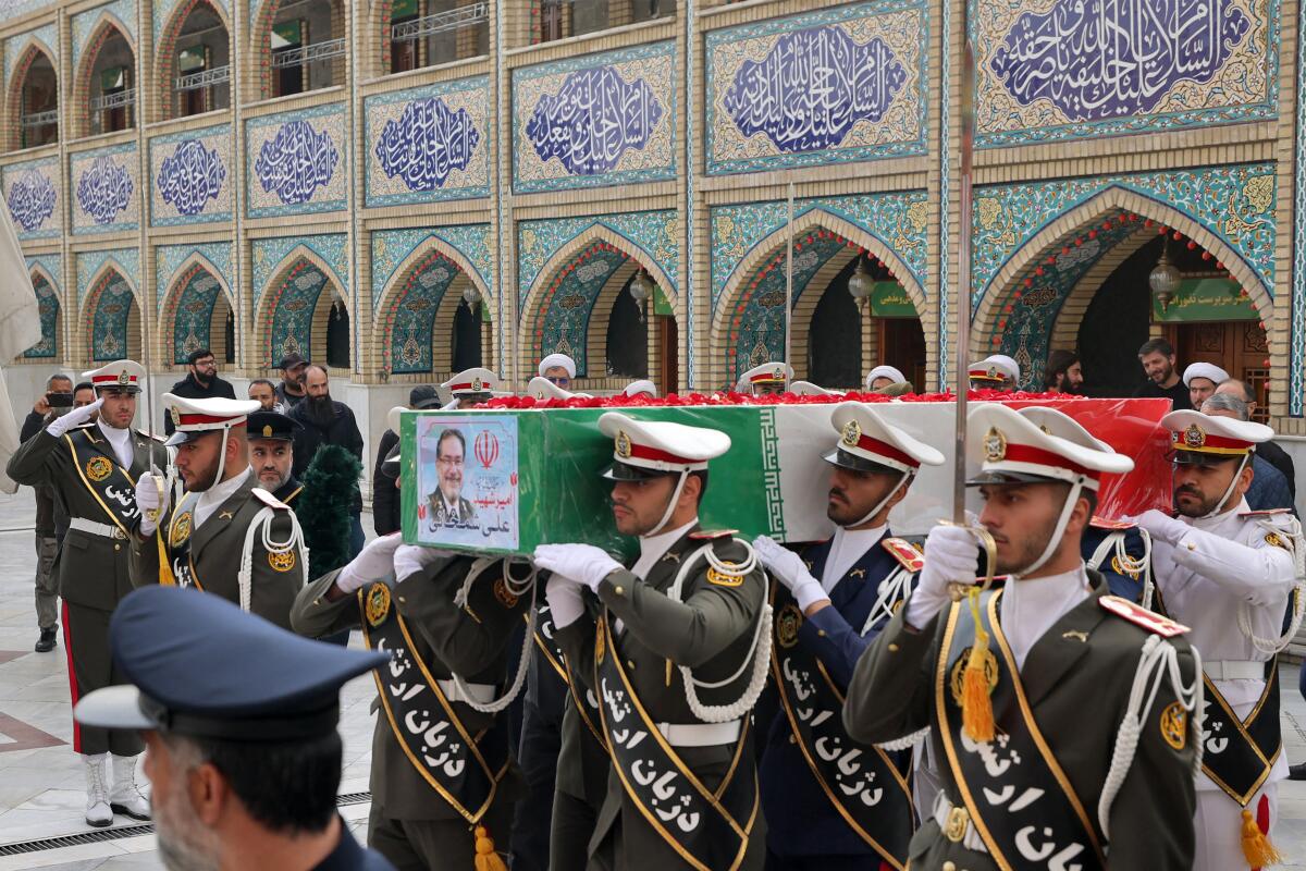 The casket of Ali Shamkhani, Iran's slain influential security adviser, proceeds during a military procession at his funeral