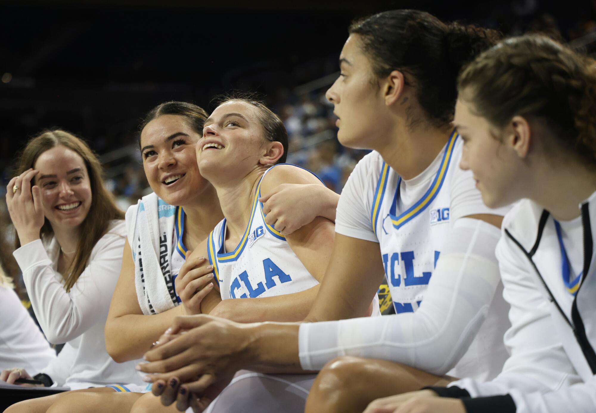 UCLA's Charlisse Leger-Walker hugs teammate Gabriela Jaquez, who led the Bruins in scoring during a win over Tennessee.