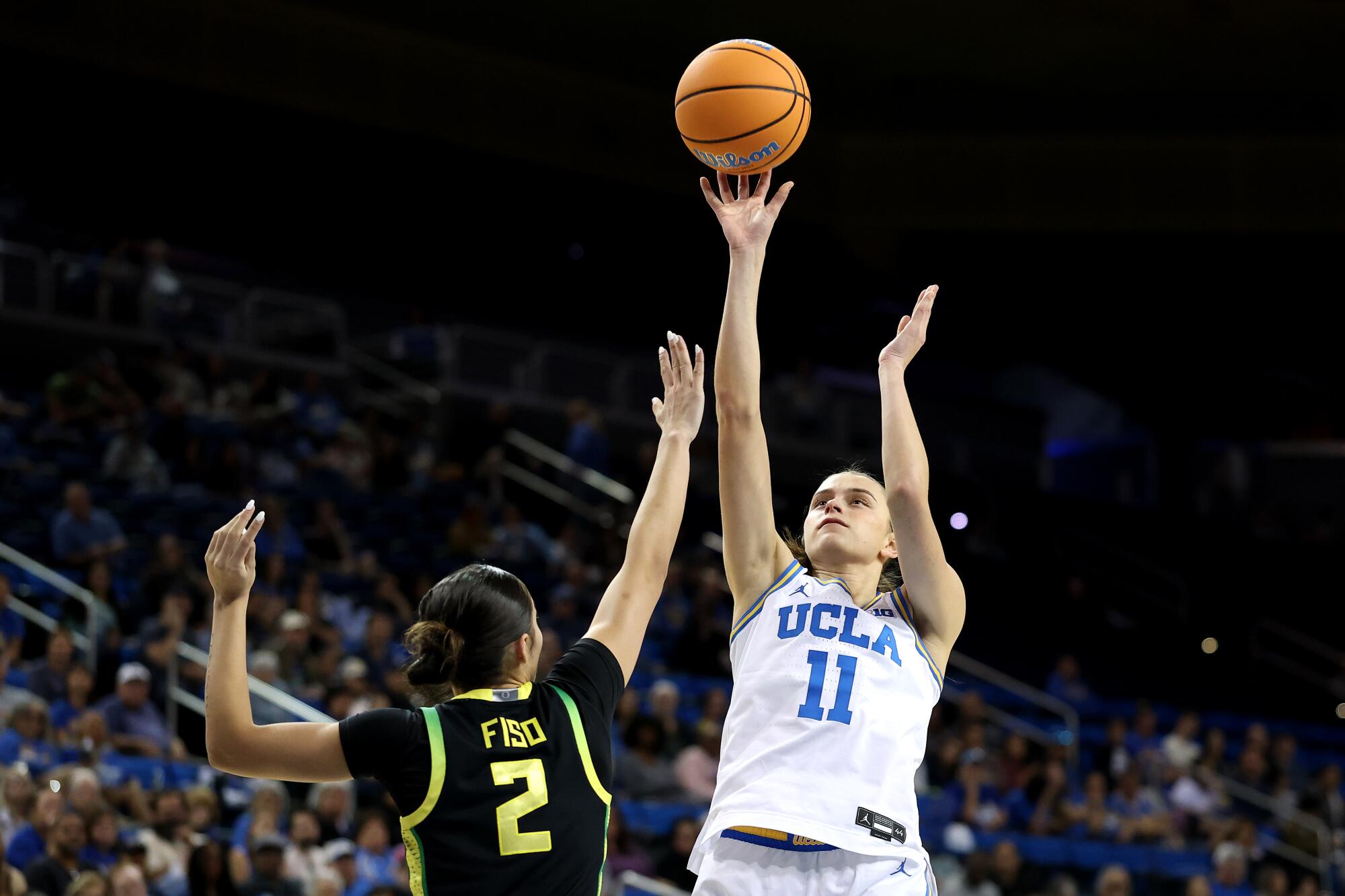 UCLA's Gabriela Jaquez shoots the ball under pressure from Oregon's Katie Fiso on Dec. 7 at Pauley Pavilion.