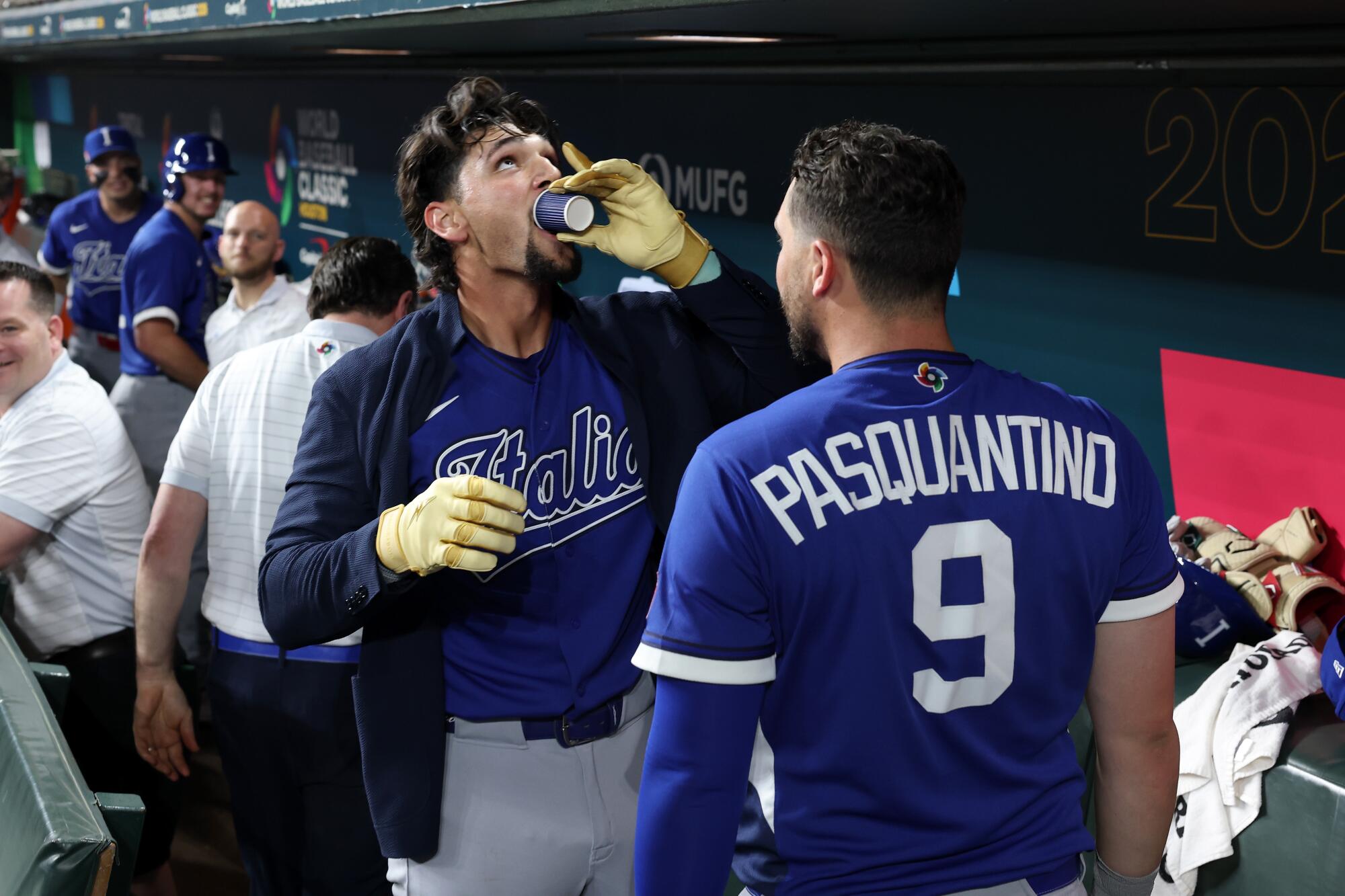 Italy's Jac Caglianone takes a shot of espresso as he celebrates with teammate Vinnie Pasquantino after hitting a homer.