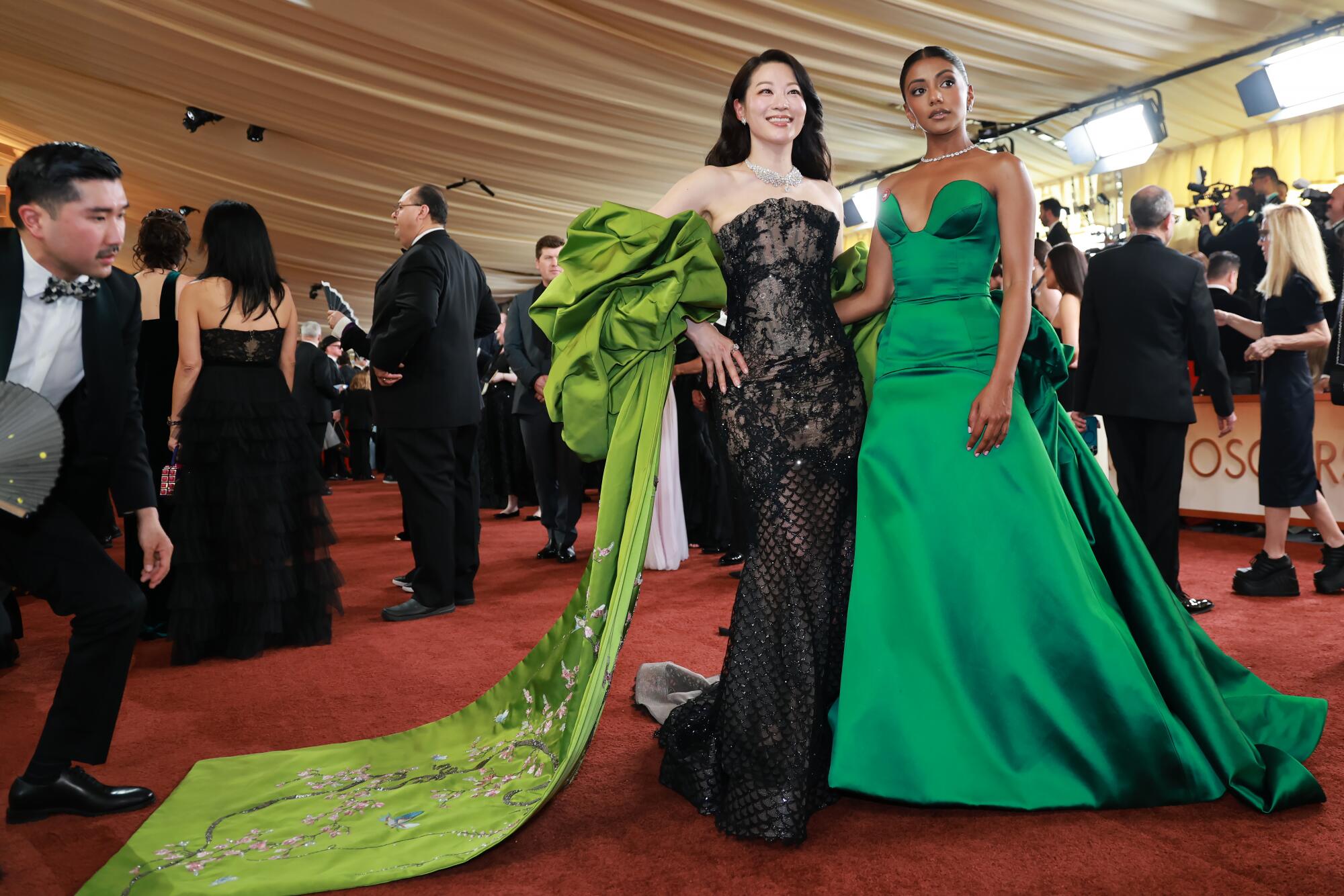 Arden Cho and Charithra Chandran pose on the red carpet.