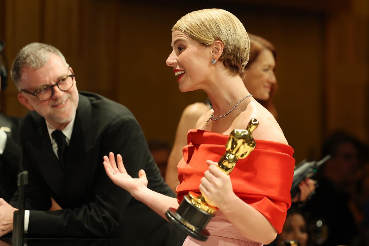Paul Thomas Anderson smiles at Jessie Buckley at the Governors Ball.