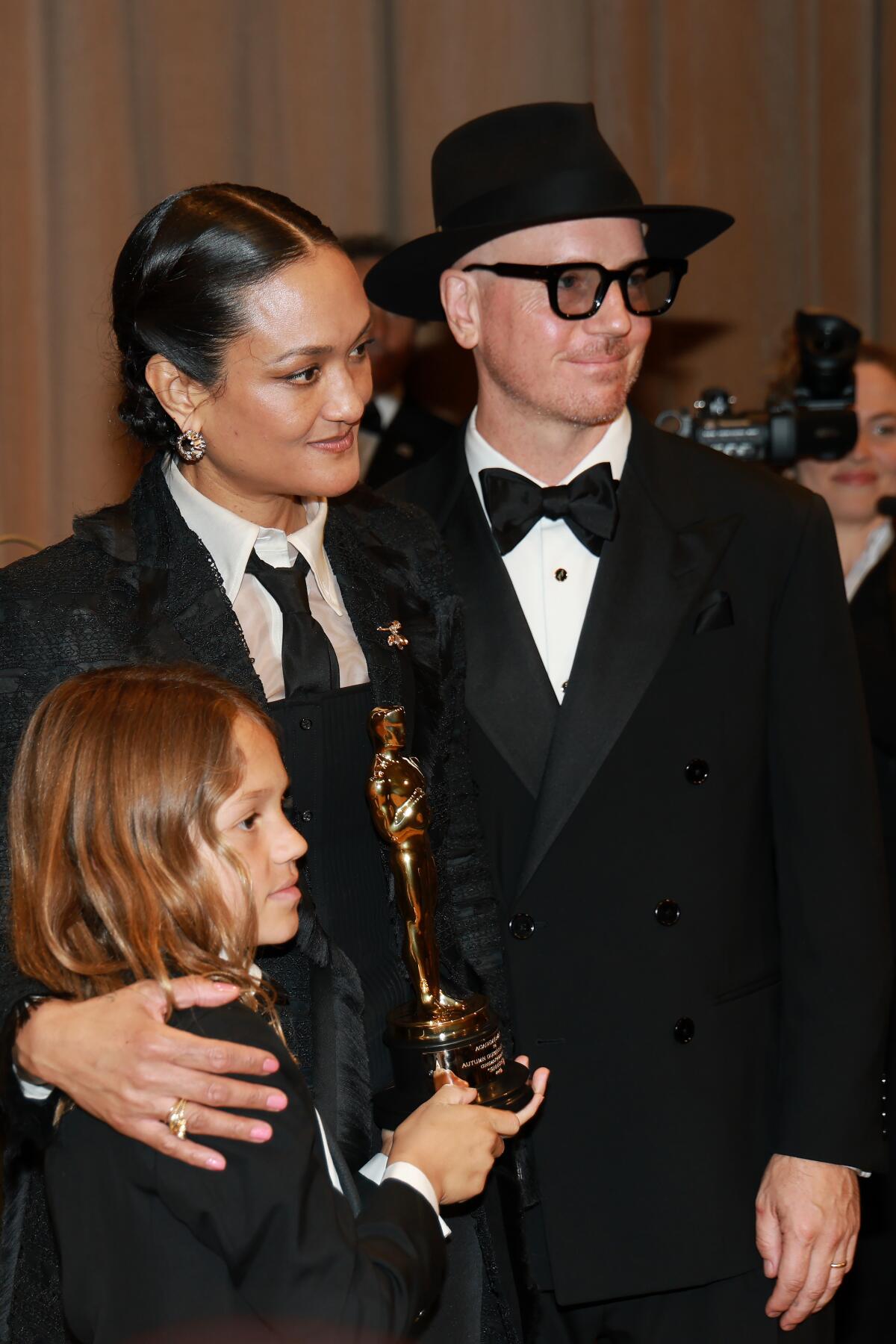 Autumn Durald Arkapaw stands next to her son who holds her Oscar. 