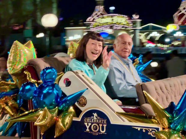 Jan Fleener, left, and Richard Ruiz -- who both have 55 years of service -- travel in an antique car along the Disney California Adventure parade route during the Celebrate You service celebration. (Photo by Brady MacDonald, Orange County Register/SCNG)