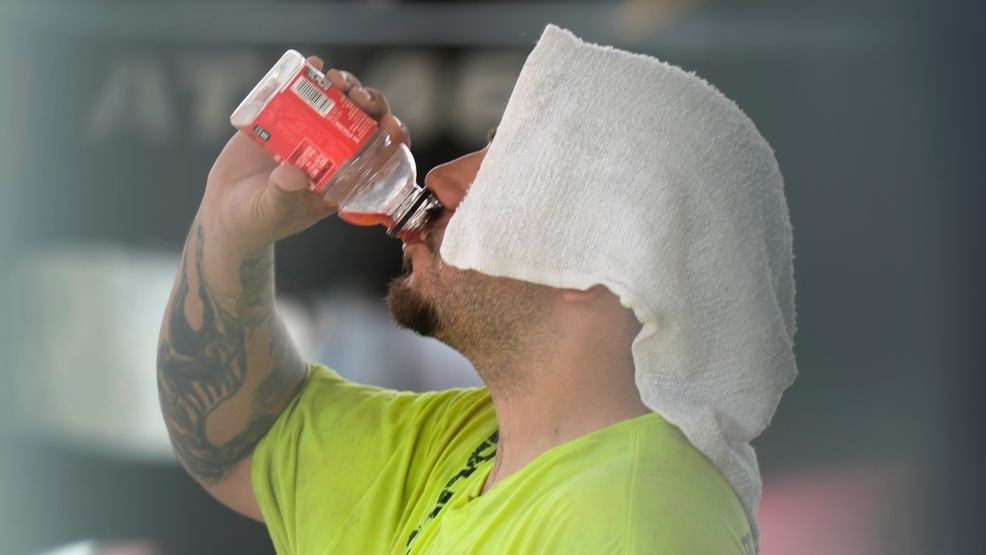 File: A construction worker hydrates at the Shedd Aquarium Tuesday, Aug. 27, 2024, as a second straight day of hot soupy temperatures approaching triple digits hung over much of the Midwest in Chicago. (AP Photo/Charles Rex Arbogast)