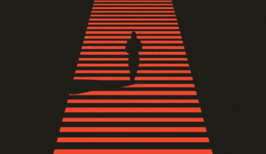 A dark silhouette of a person walks across a red and black striped crosswalk, casting a long shadow behind them.