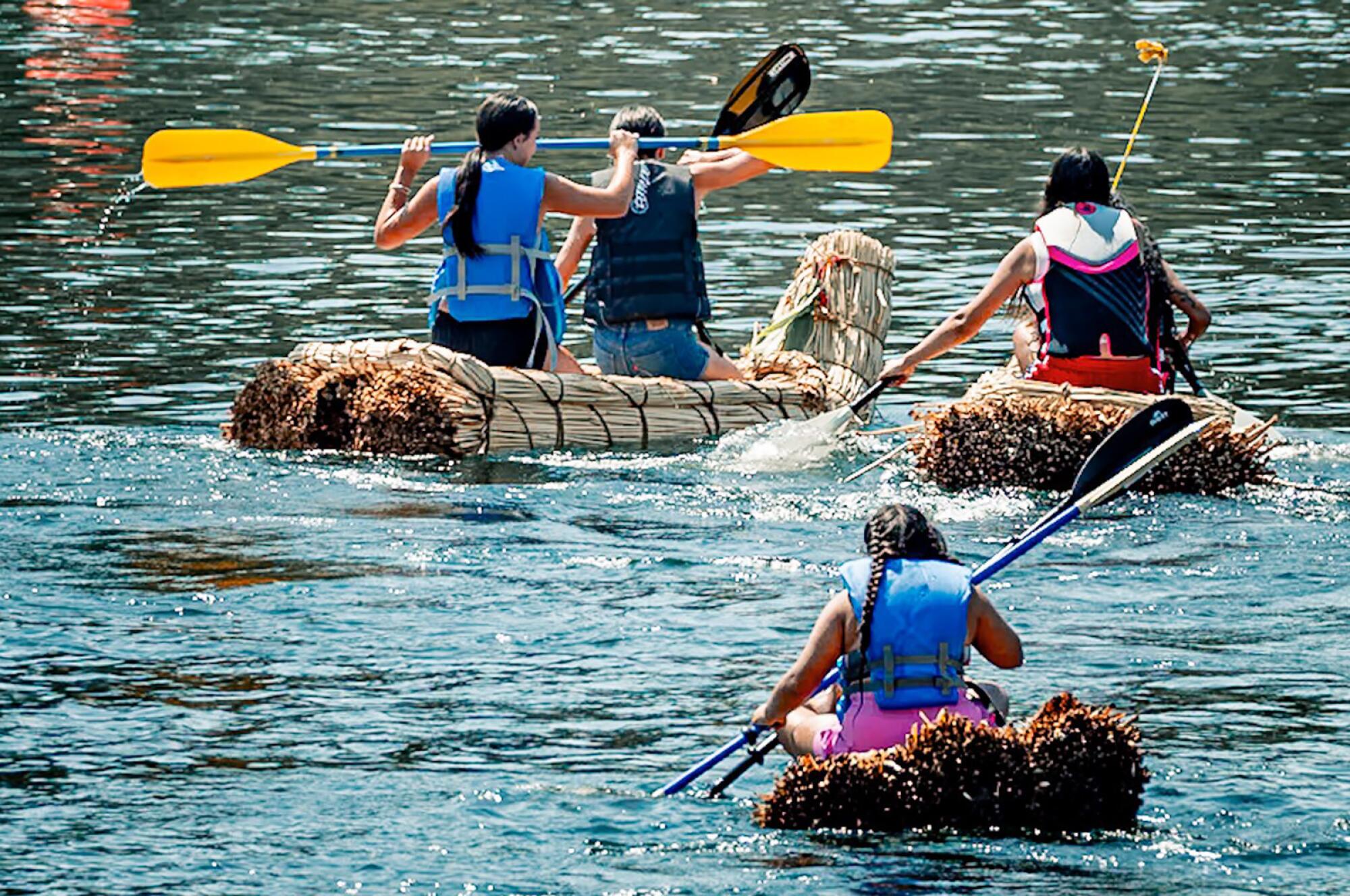 Tribal members on tule boats