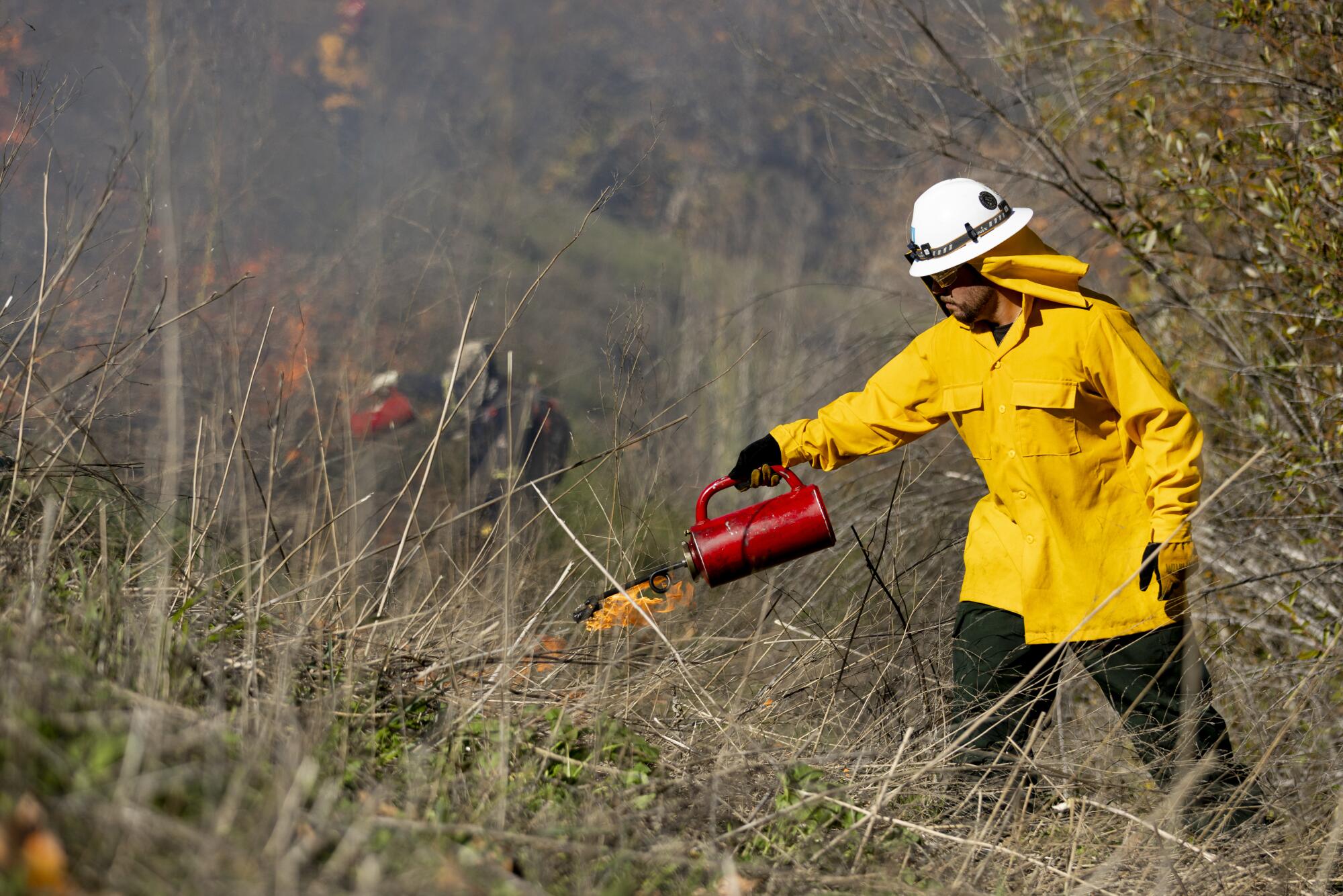a member of the yak titʸu titʸu yak tilhini Northern Chumash Tribe, participates in a cultural burn
