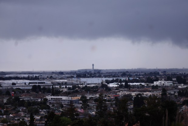 Storm clouds are seen over the Oakland San Francisco Bay Airport in a view from San Leandro, Calif., on Wednesday, Feb. 11, 2026. More rain is forecast for the weekend. (Jane Tyska/Bay Area News Group)