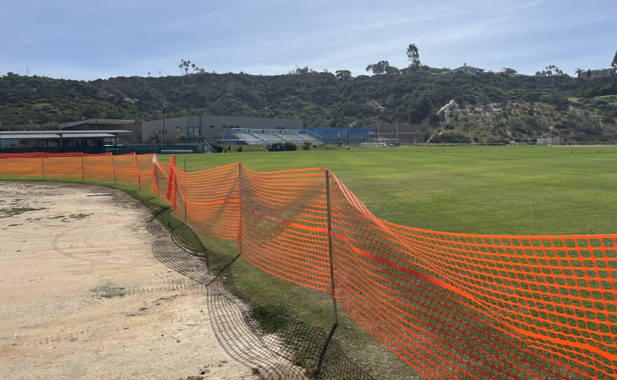 Construction fencing blocks off where a dirt softball field will soon be converted to grassy soccer space at San Diego Jewish Academy, March 16, 2026.