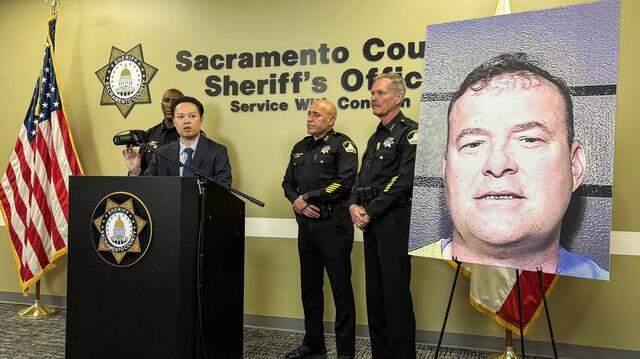 Sacramento County District Attorney Thien Ho, center, speaks during a news conference Thursday, March 12, 2026, at the Sacramento County Sheriff’s Headquarters. Ho and Sheriff Jim Cooper, left; Assistant Sheriff Salvador Robles, center right; and Undersheriff Mike Ziegler, far right; gathered to call for reform to California’s Elderly Parole Program in response to the planned release of Gregory Vogelsang, pictured on the poster.