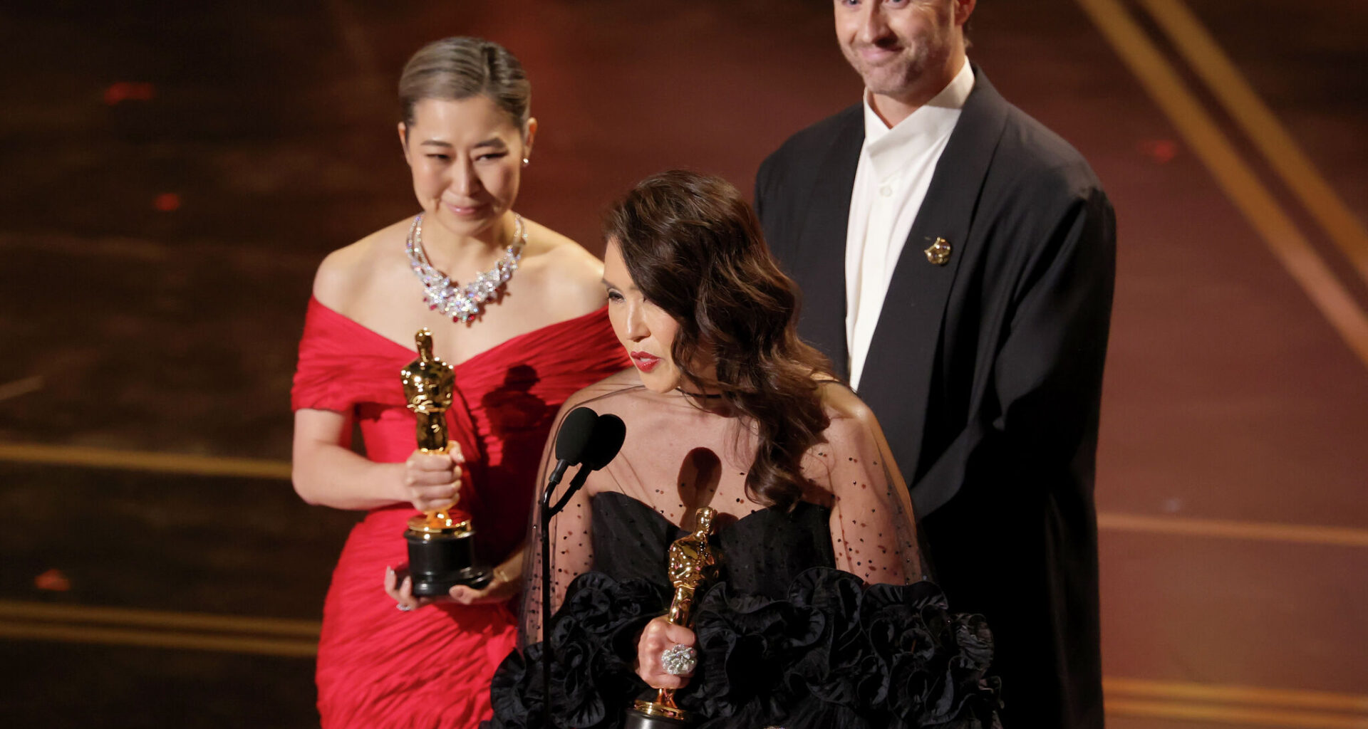 Maggie Kang, left, Michelle L.M. Wong and Chris Appelhans accept the best animated feature film award for “KPop Demon Hunters” onstage during the 98th Oscars at Dolby Theatre on March 15, 2026 in Hollywood.