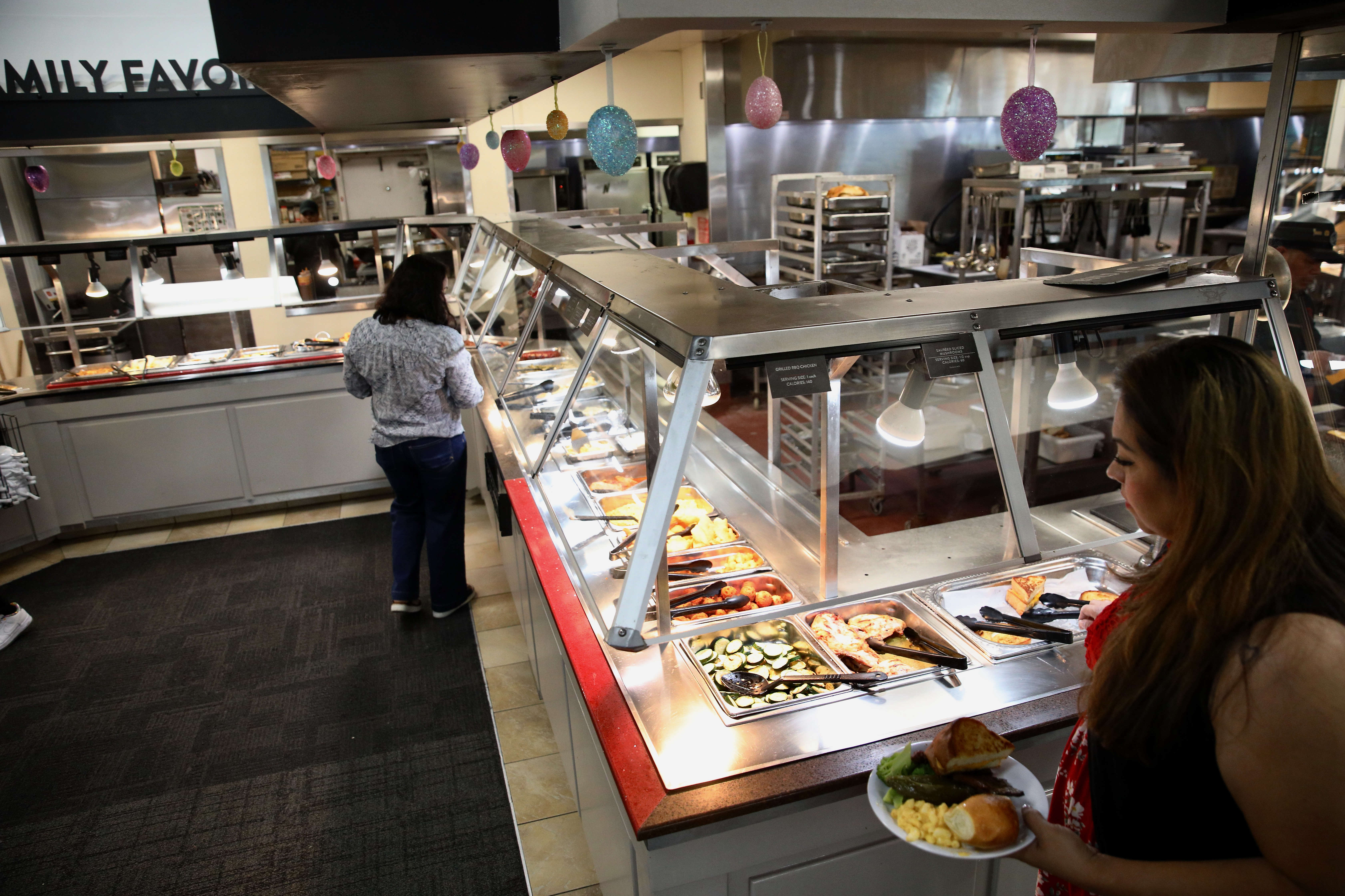 Patrons visit the buffet during lunch hour at Golden Corralâs...
