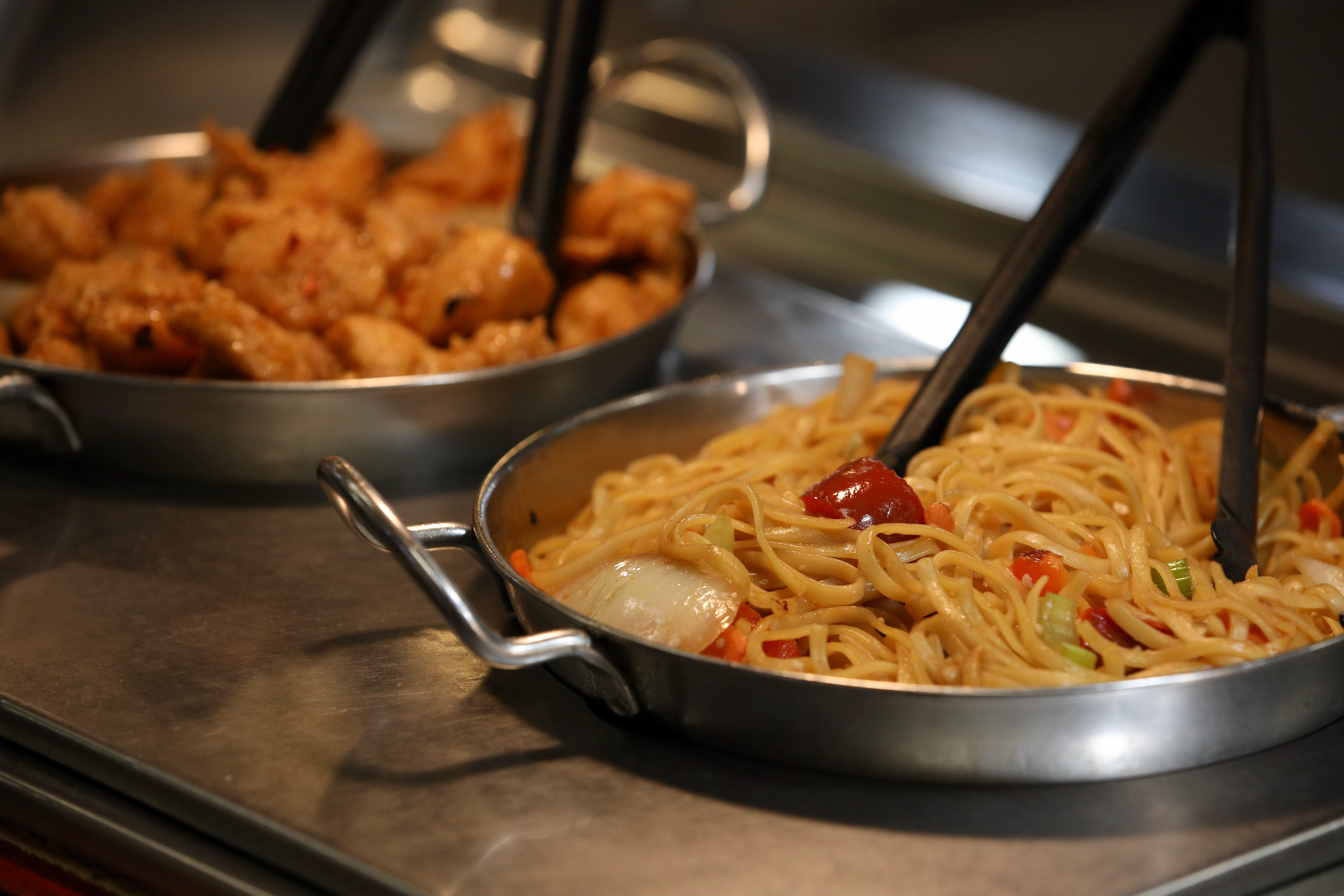 Asian noodles and orange chicken are offered in the buffet...