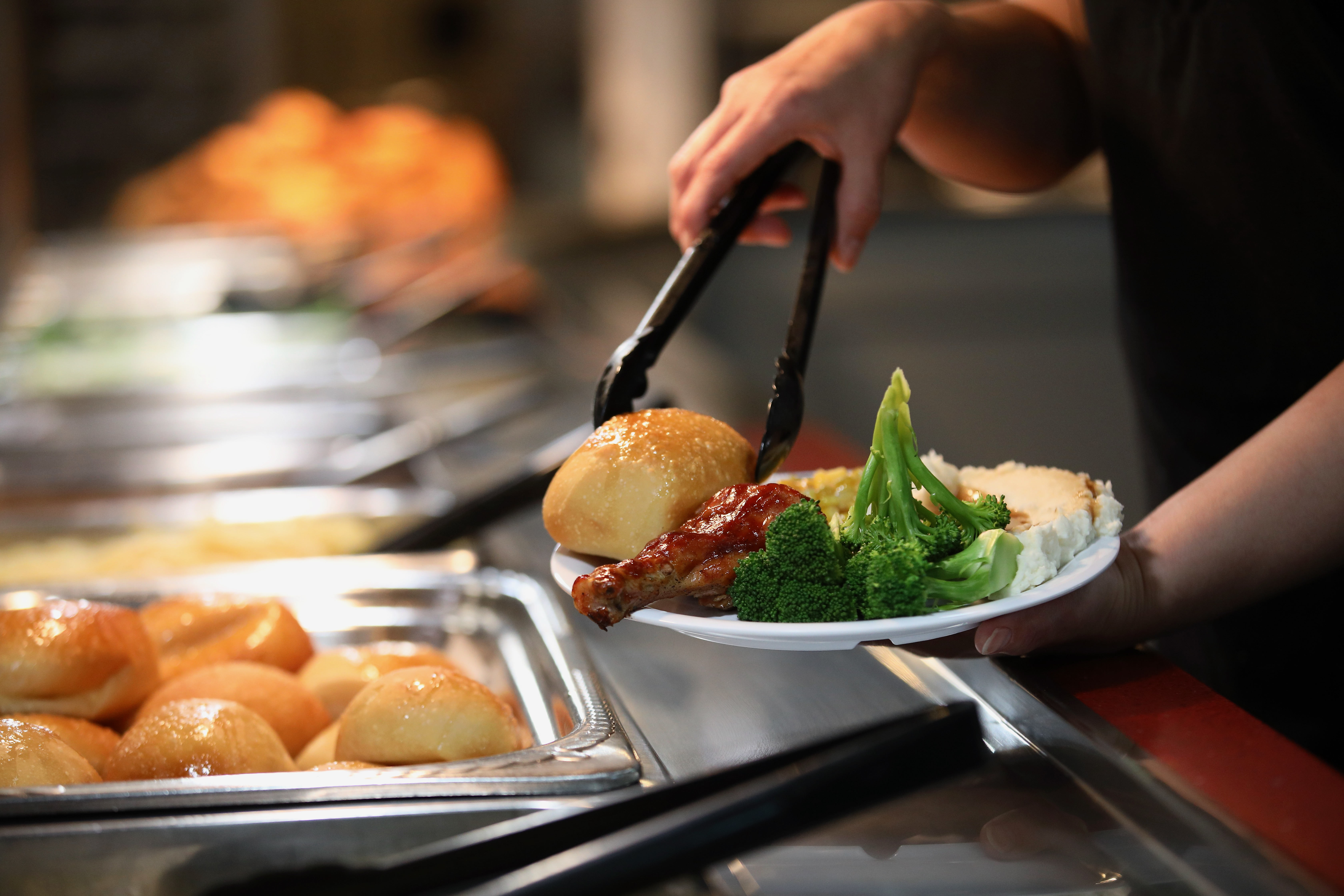 A patron visits the buffet during lunch hour at Golden...