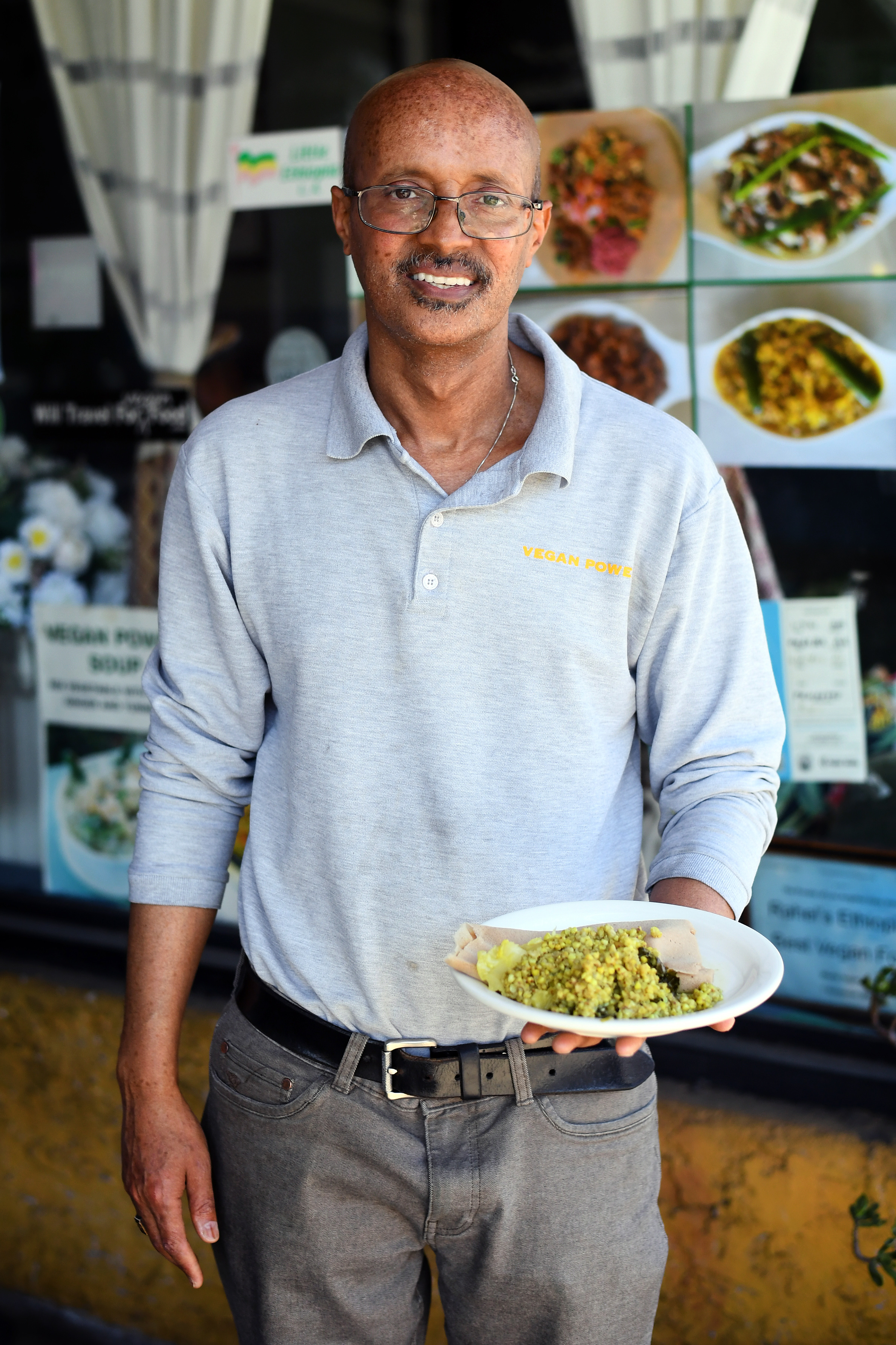 Owner Wondu Haile presents a mixed plate of dishes from...