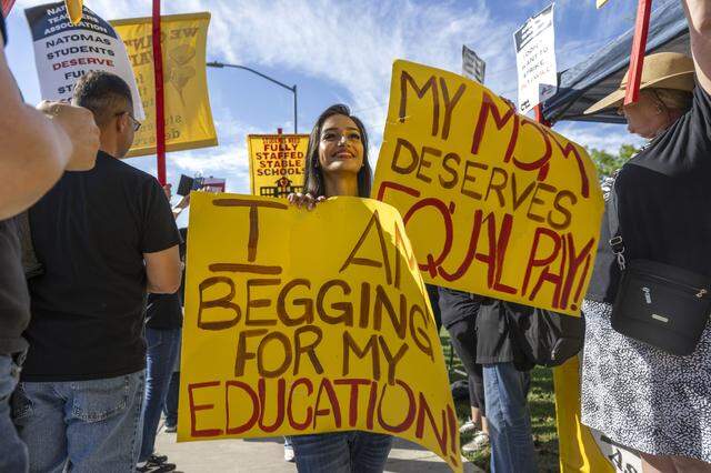 Ashlyn Aravhna, 17, a senior at Natomas High School, joins a student walk out during a teachers strike on Monday outside of the Natomas Unified School District offices. Aravhna said she made the two-mile march from the high school to support her mother, who is a teacher. 