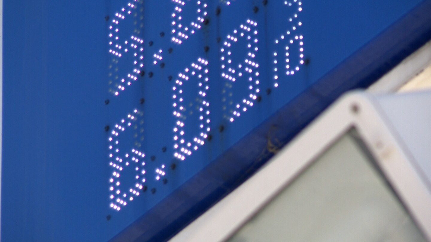 A premium gasoline price of $6.09 per gallon is shown on a lighted sign at a gas station in the College Area on March 19, 2026.